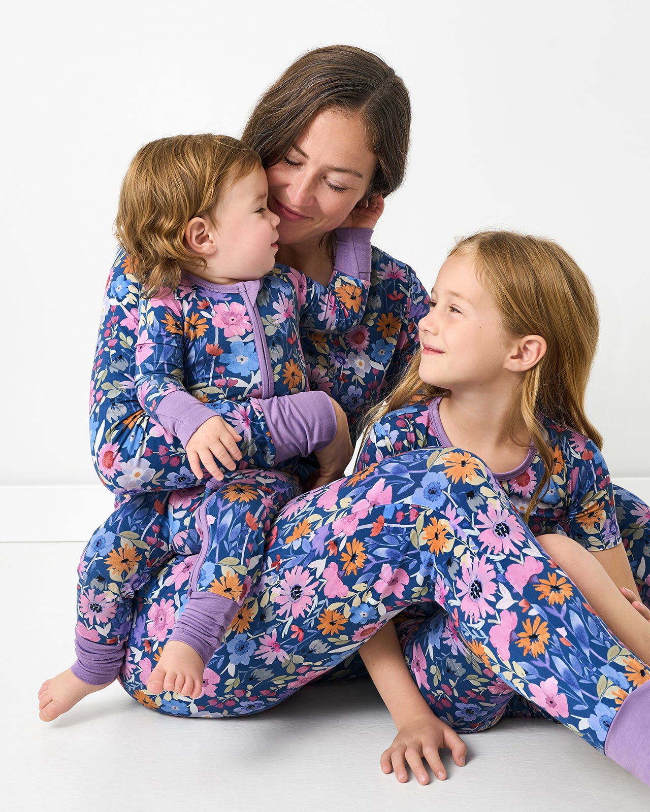 Mother and two children wearing matching Dusk Blooms floral bamboo pajamas