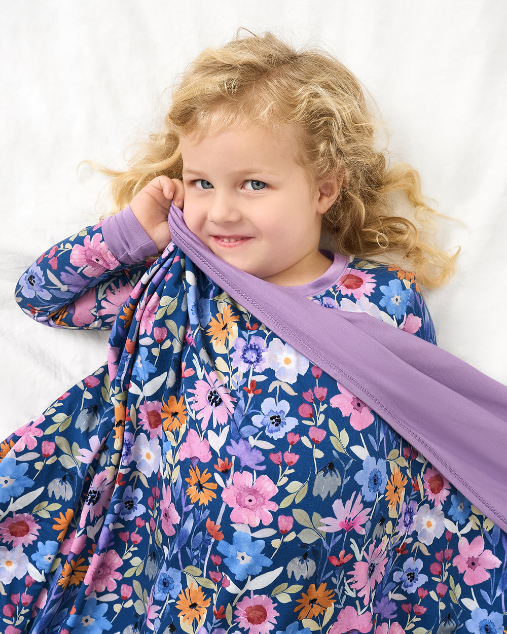 Aerial view of girl wrapped in the Dusk Blooms Large Cloud Blanket®