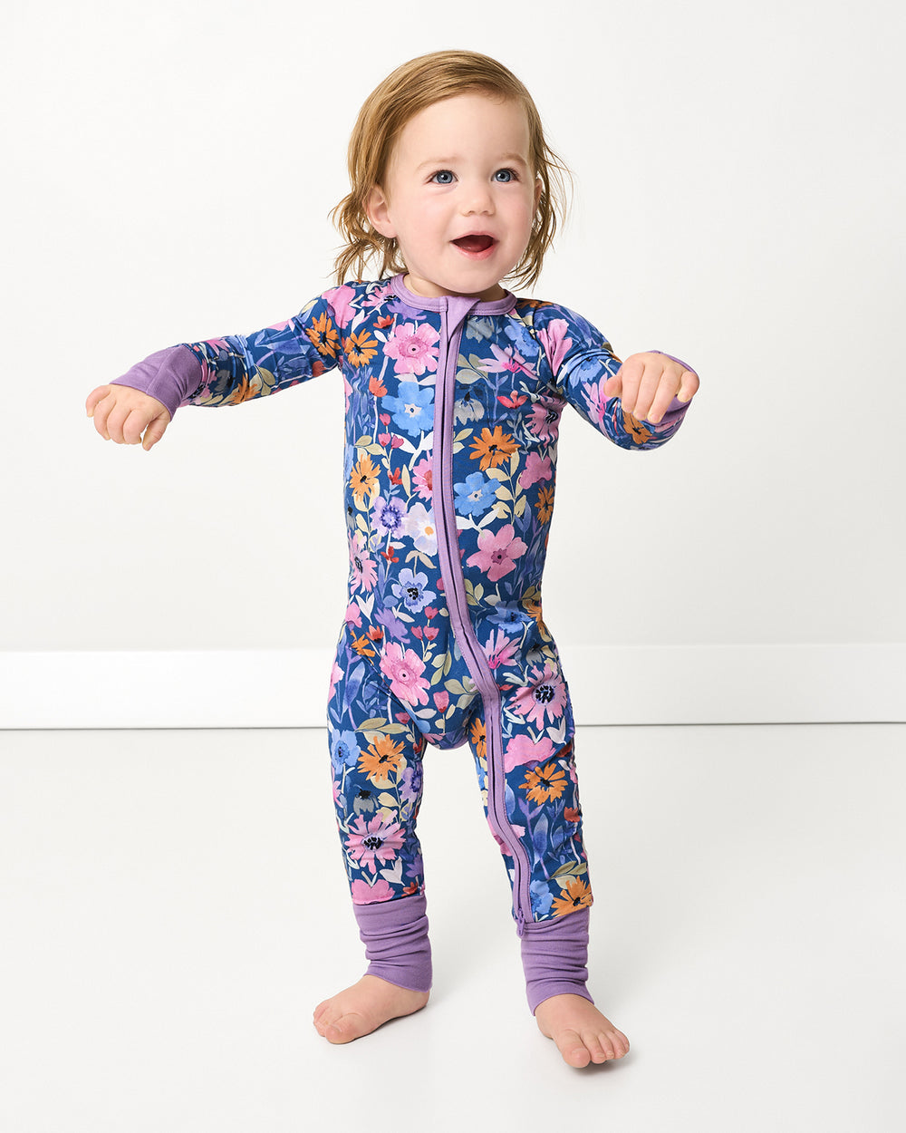 Standing child wearing the Dusk Blooms Zippy