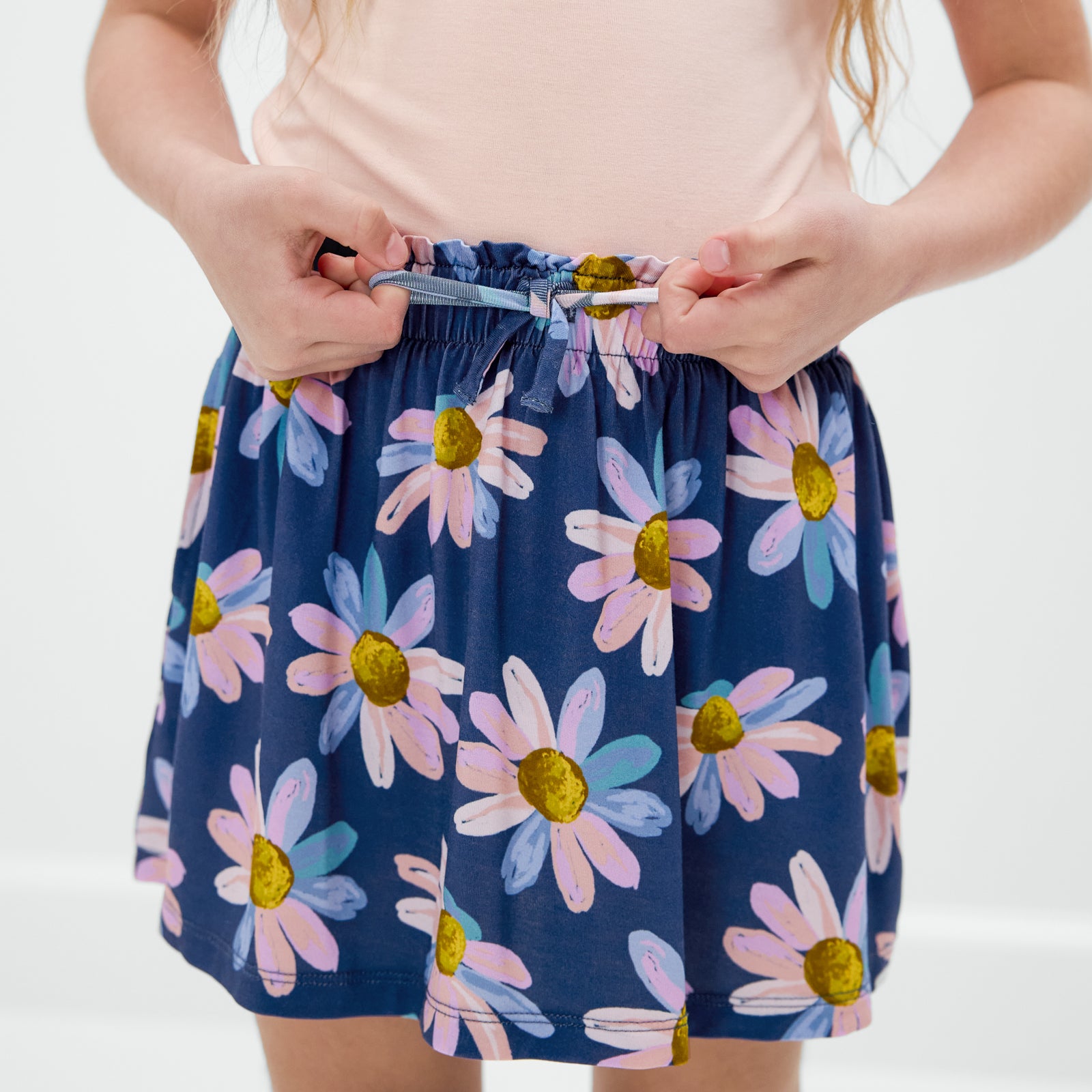 Close up of child wearing the Daisy Blooms Skort