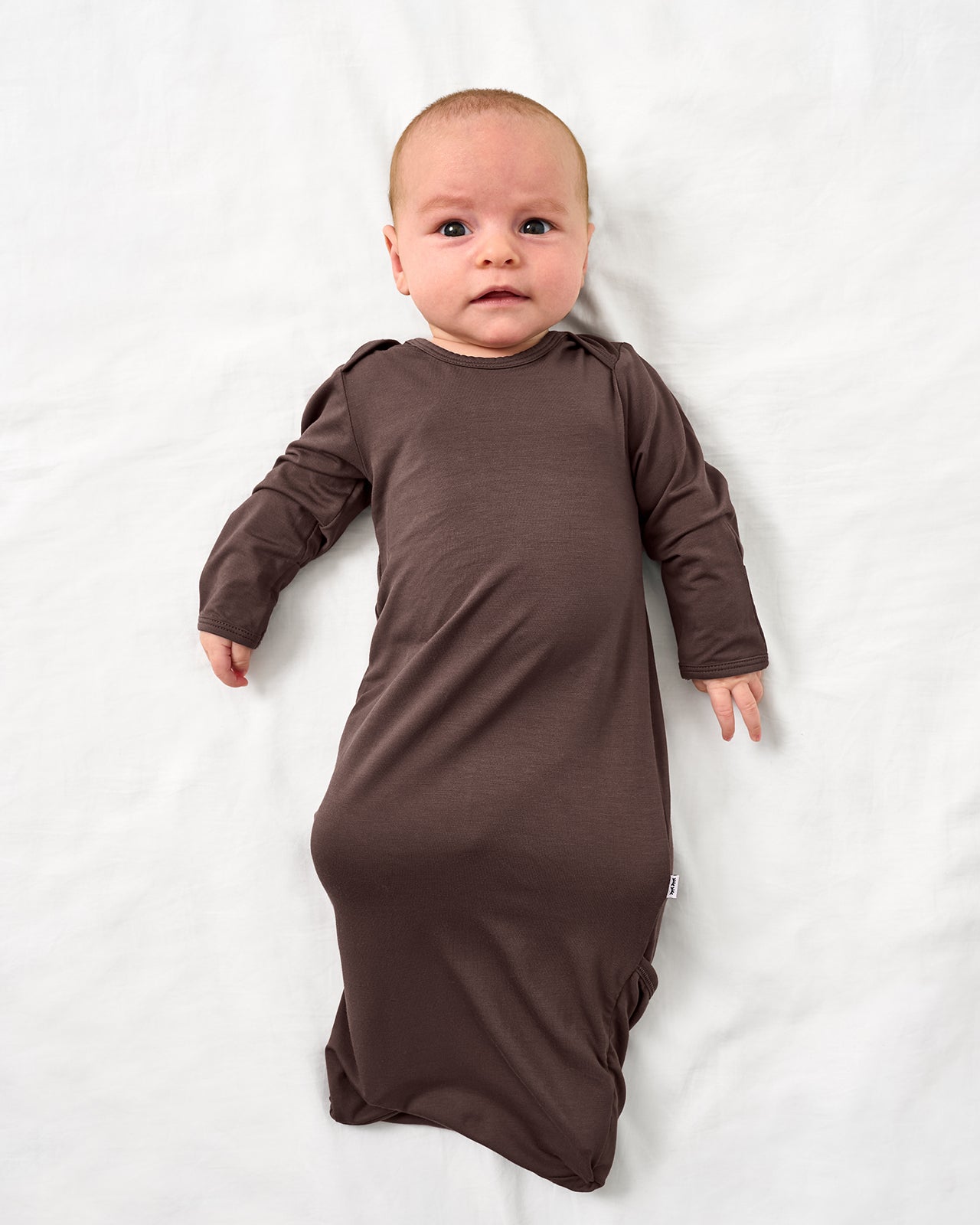 Aerial view of baby wearing the Dark Chocolate Infant Gown