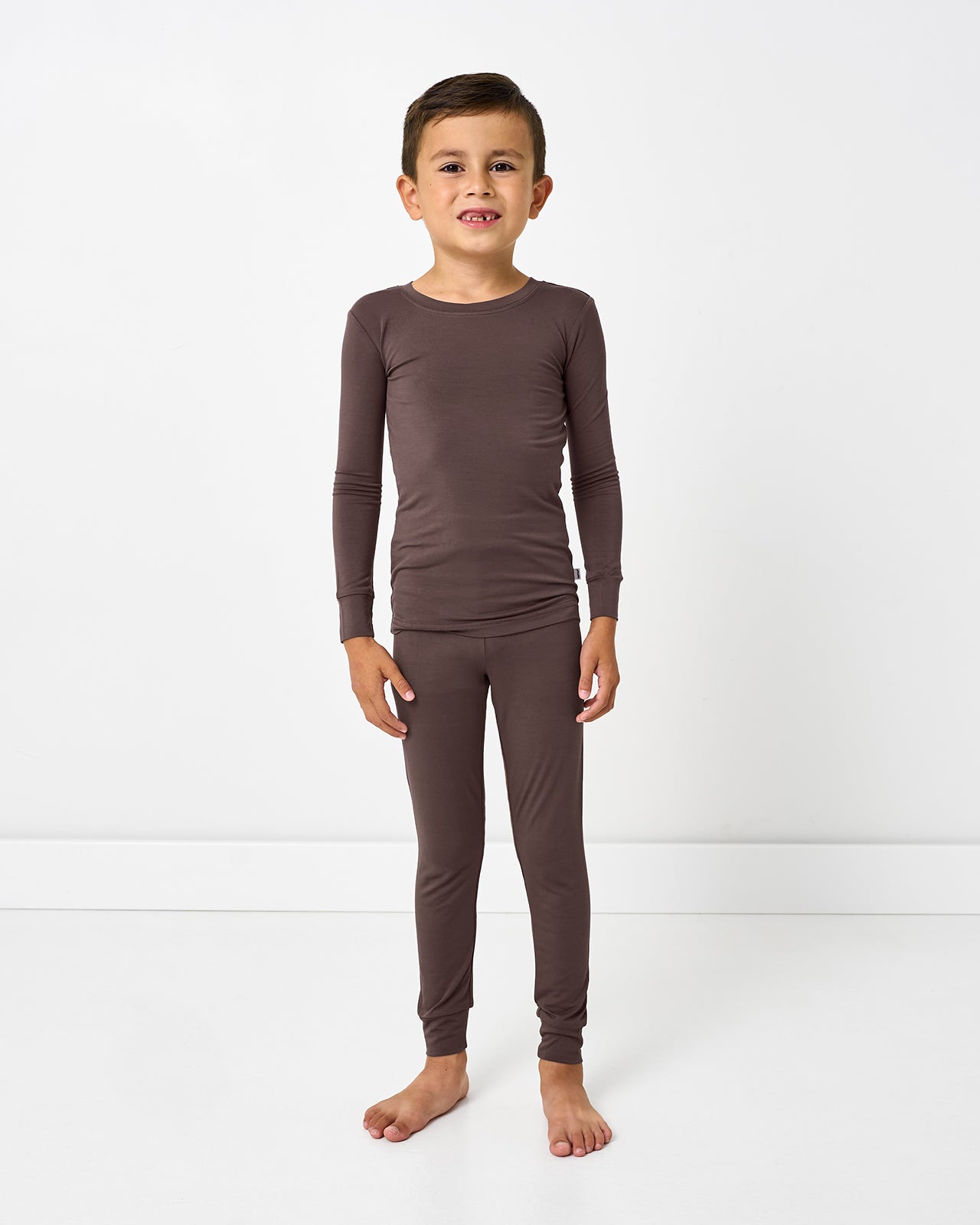 Standing boy wearing the Dark Chocolate Two-Piece Pajama Set