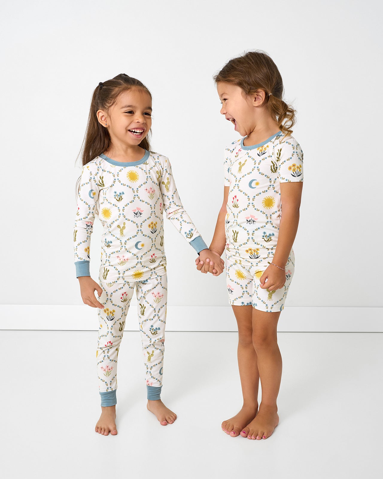 Two girls wearing matching Desert Meadow Two-Piece Pajama Sets