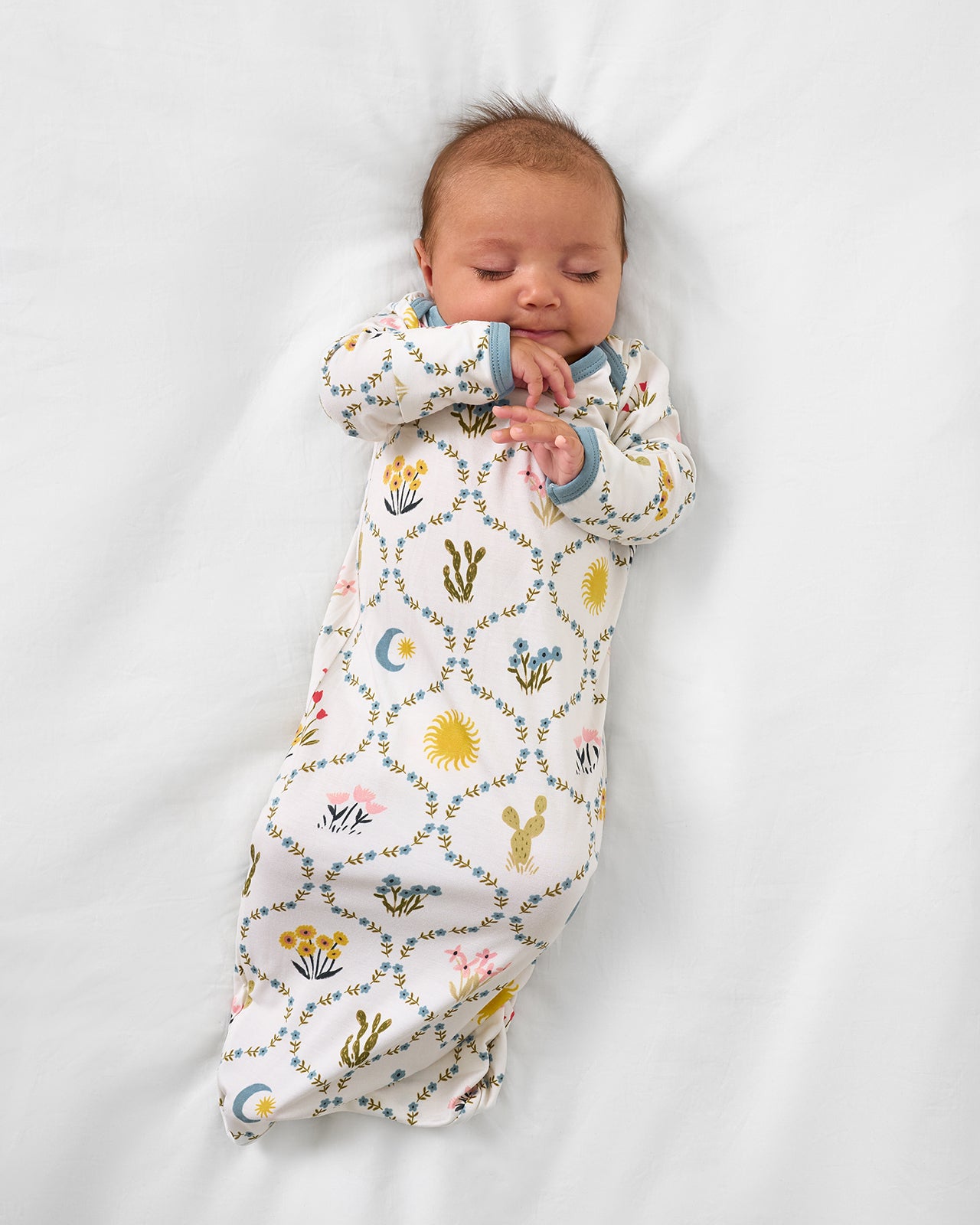 Aerial view of newborn wearing the Desert Meadow Infant Gown
