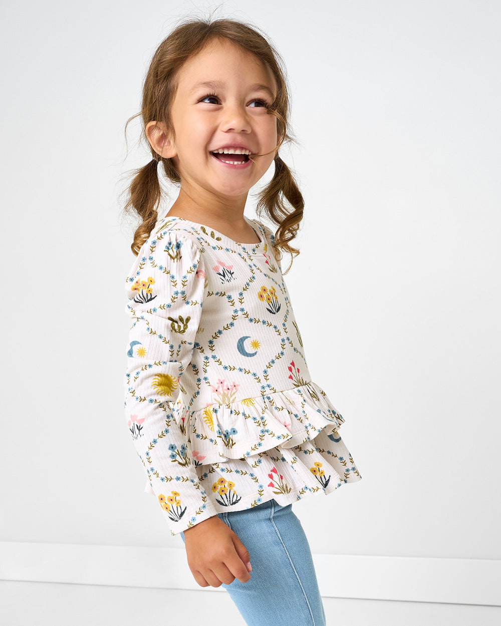 Girl wearing the Desert Meadow Ribbed Tiered Peplum Top