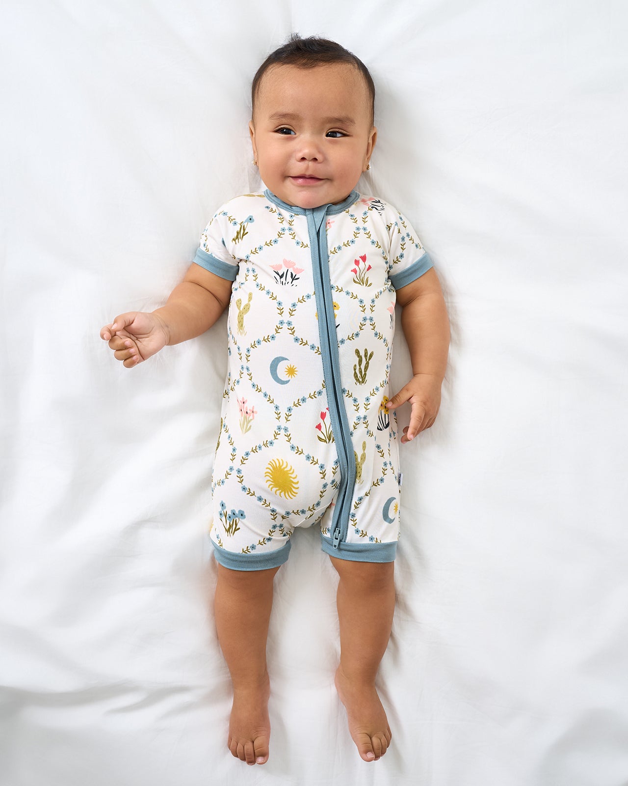 Aerial view of baby wearing the Desert Meadow Shorty Zippy