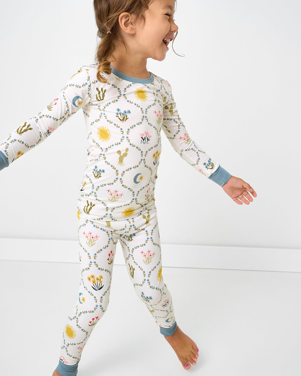 Child in motion wearing the Desert Meadow Two-Piece Pajama Set