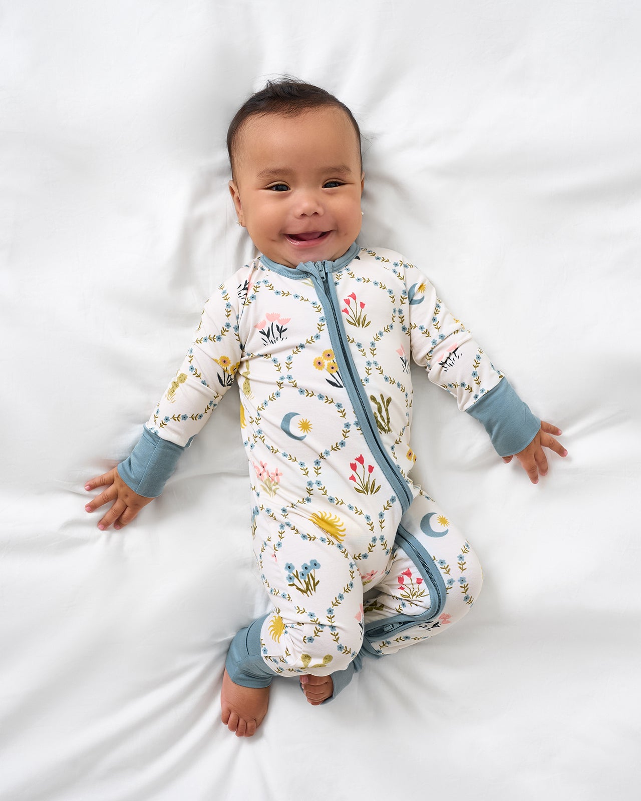 Alternate aerial view of baby wearing the Desert Meadow Zippy