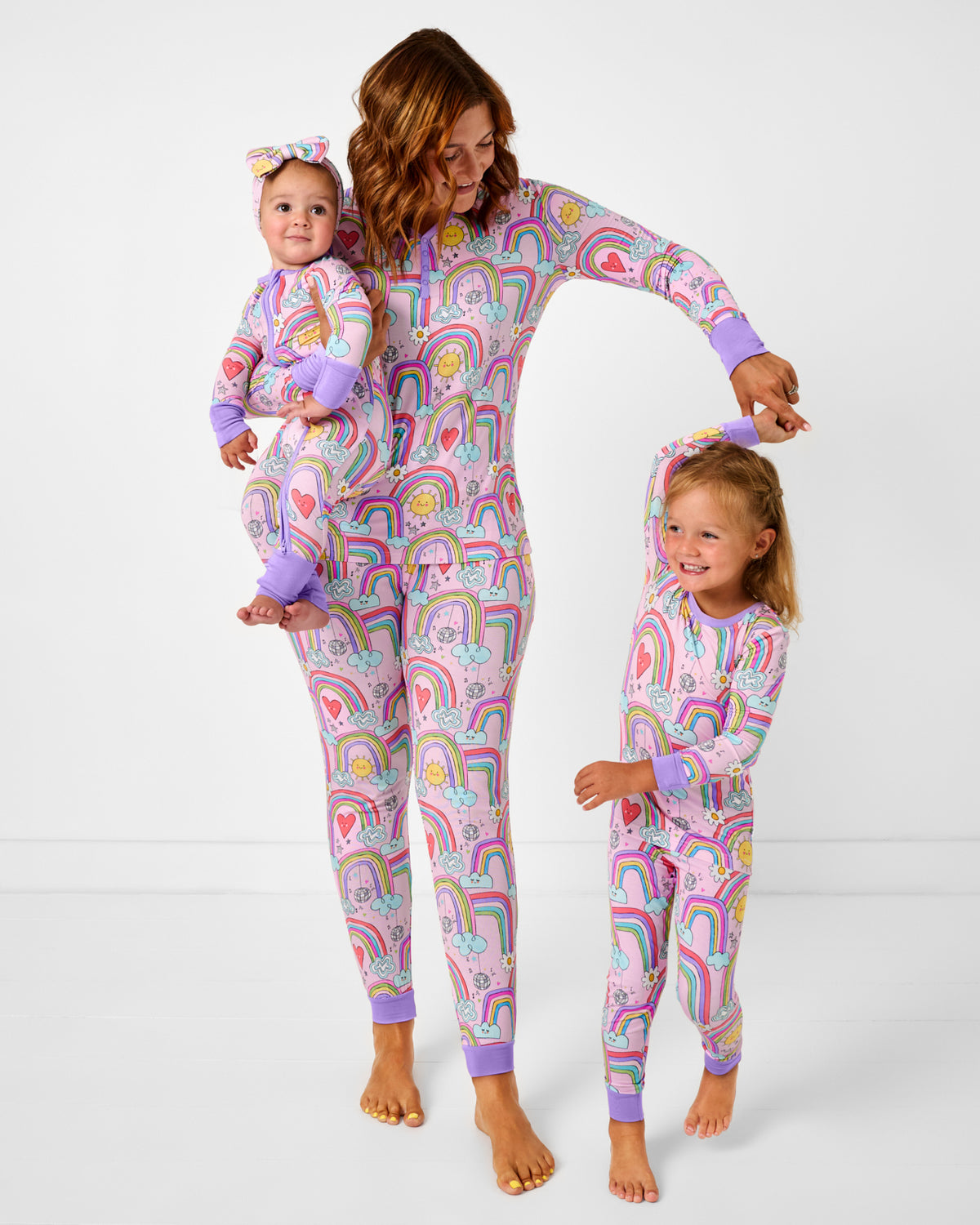 Mother and two children wearing matching Disco Rainbows bamboo pajamas