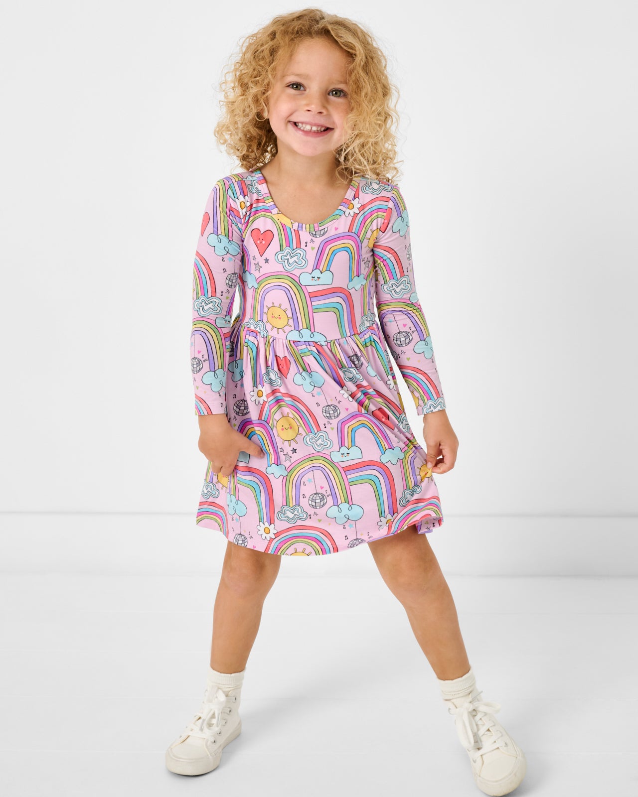 Standing girl wearing the Disco Rainbows Skater Dress