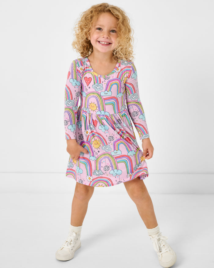 Standing girl wearing the Disco Rainbows Skater Dress