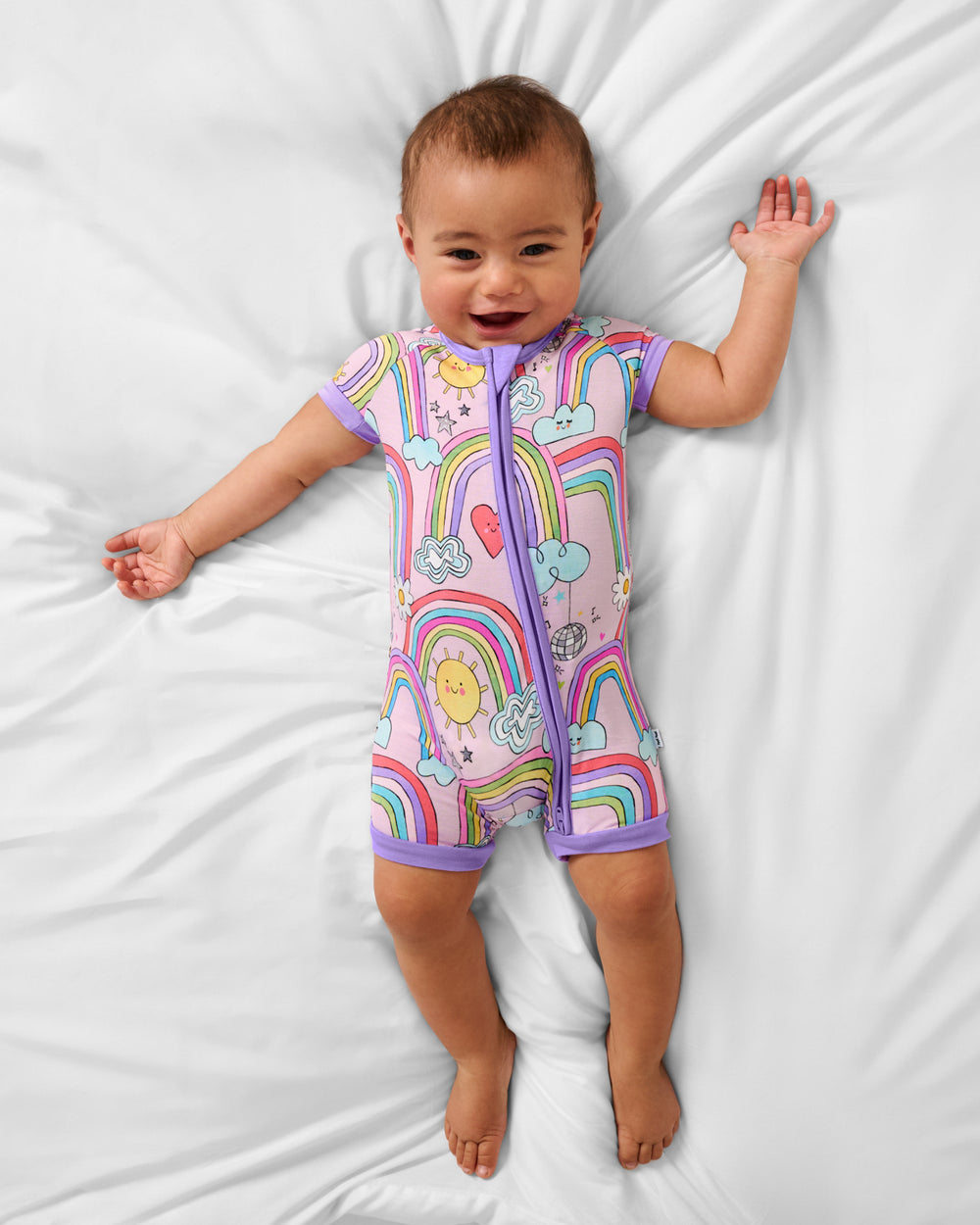 Aerial view of baby wearing the Disco Rainbows Shorty Zippy