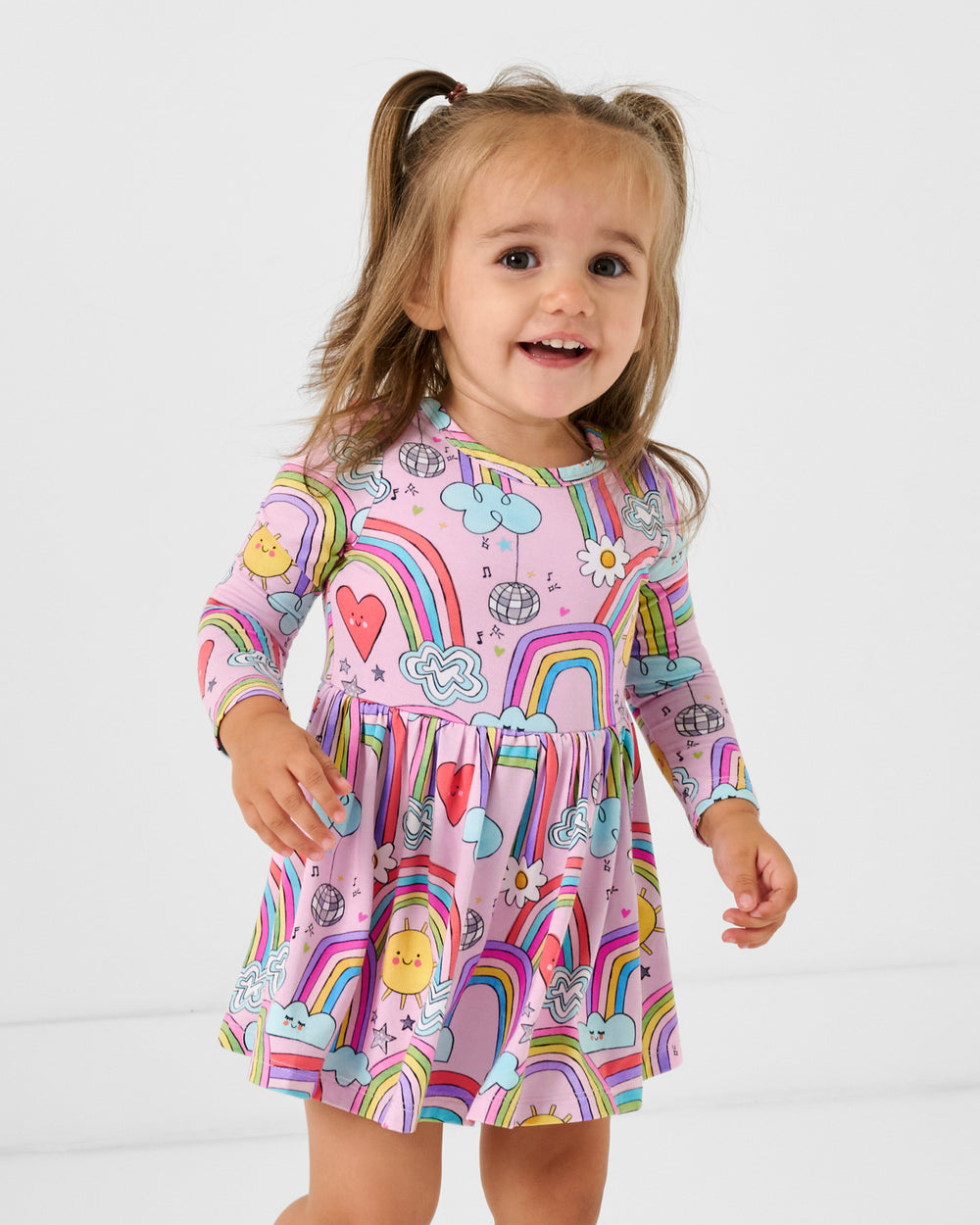 Girl wearing the Disco Rainbows Skater Dress with Bodysuit