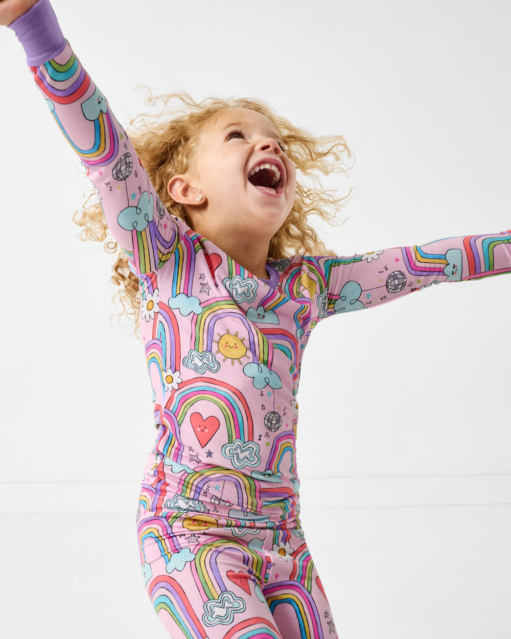 Posing girl wearing the Disco Rainbows Two-Piece Pajama Set