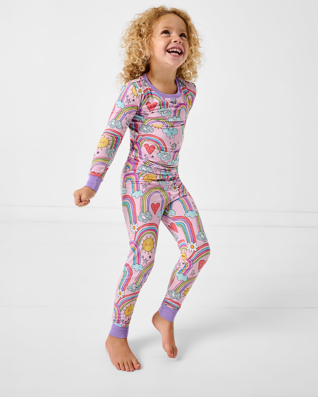 Girl wearing the Disco Rainbows Two-Piece Pajama Set
