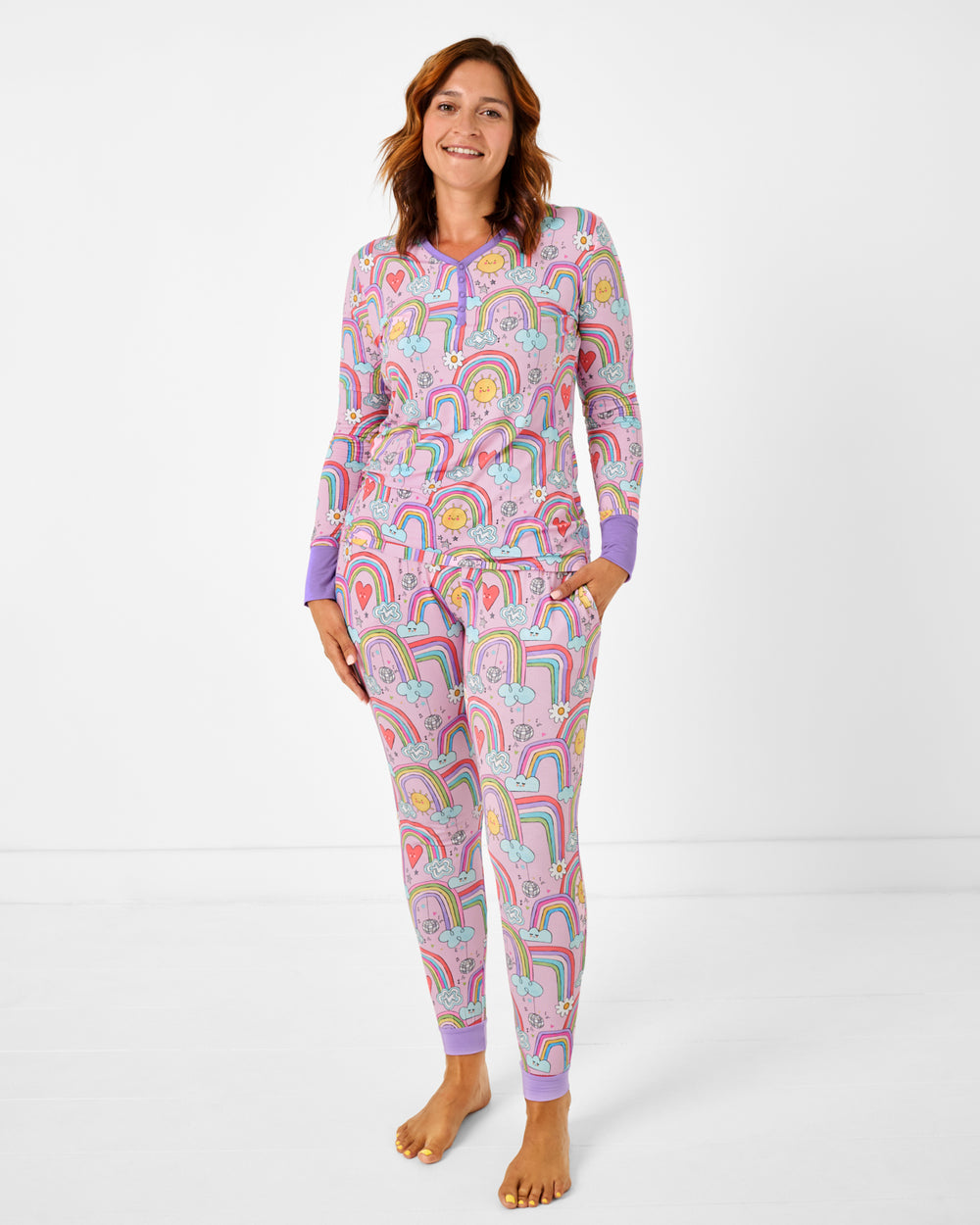 Standing woman wearing the Disco Rainbows Women's Long Sleeve Pajama Top and Pants