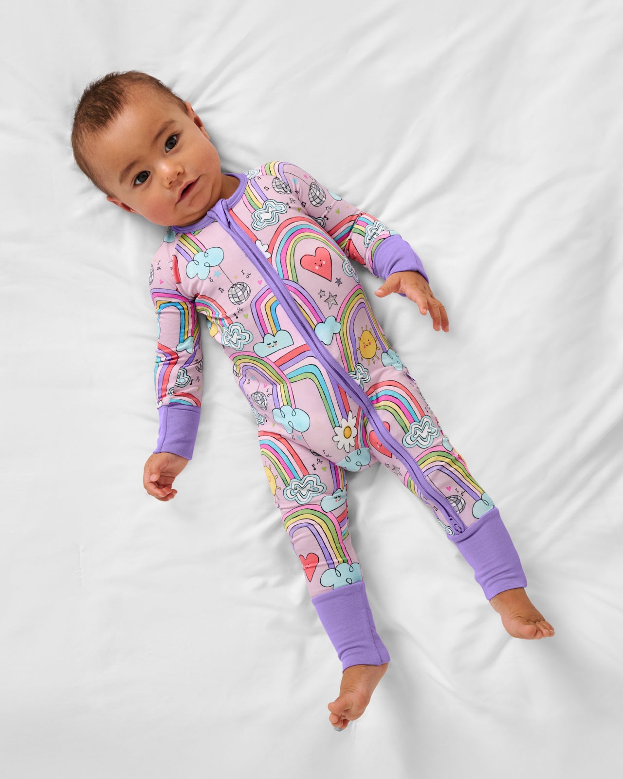 Aerial view of baby wearing the Disco Rainbows Zippy