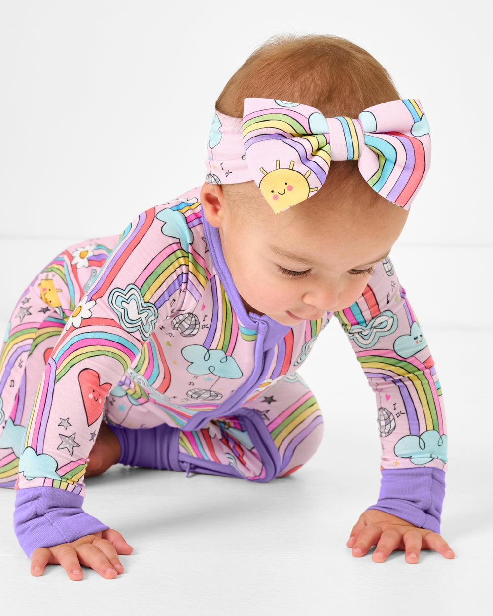 Crawling baby wearing the Disco Rainbows Luxe Bow Headband
