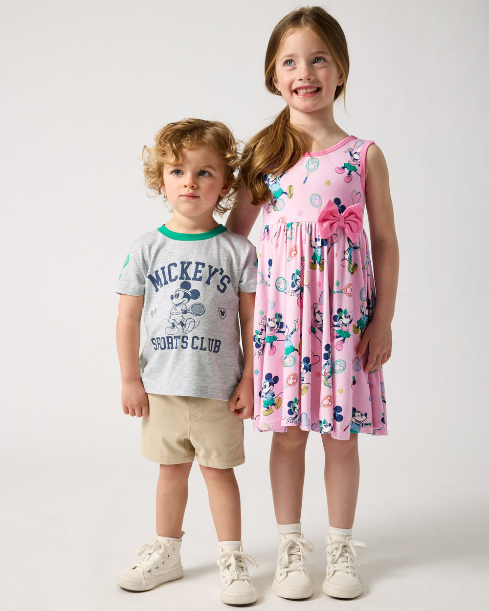 Two children wearing Disney Mickey Mouse Sports Club Varsity styles