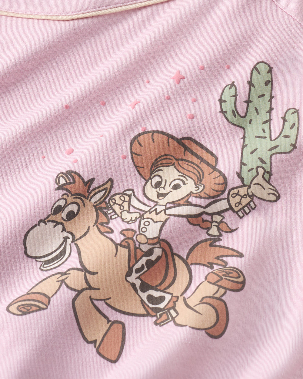 Flat lay of the graphic detail on the Disney & Pixar Howdy Jessie Puff Sleeve Tee