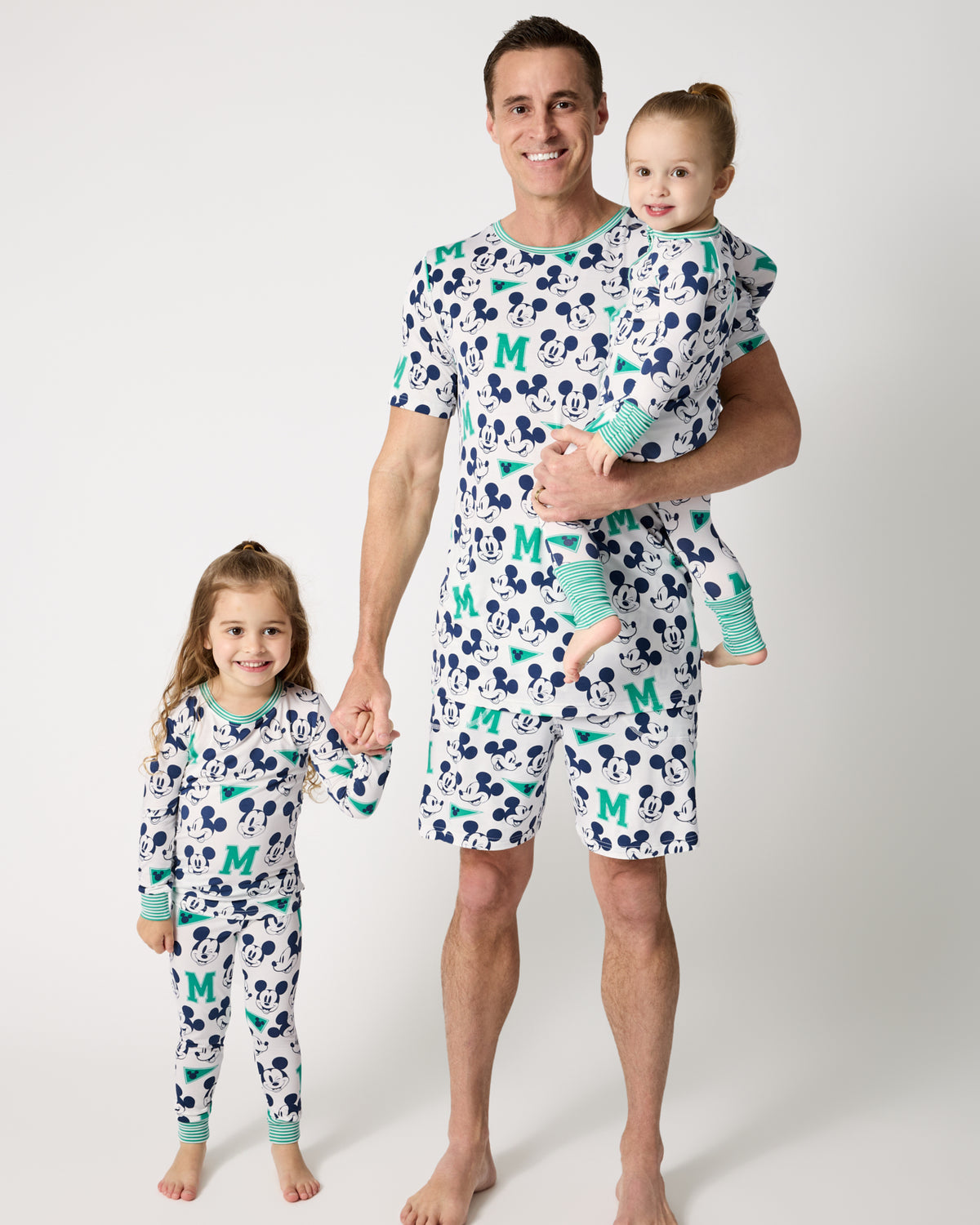 Father and two children wearing matching Disney Varsity Mickey Mouse pajamas