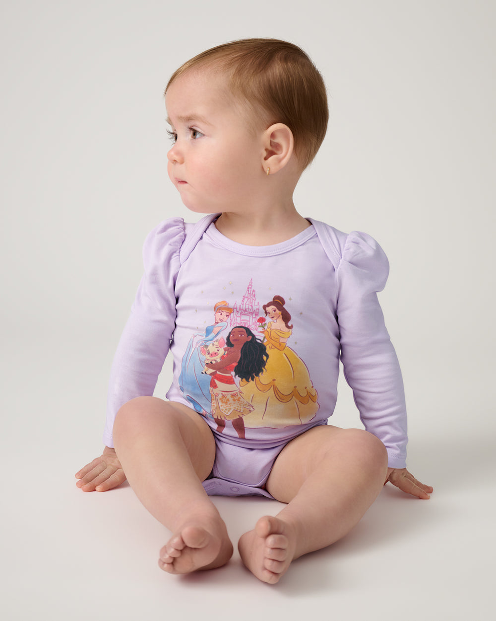 Sitting baby wearing the Disney Castle Daydream Puff Sleeve Bodysuit