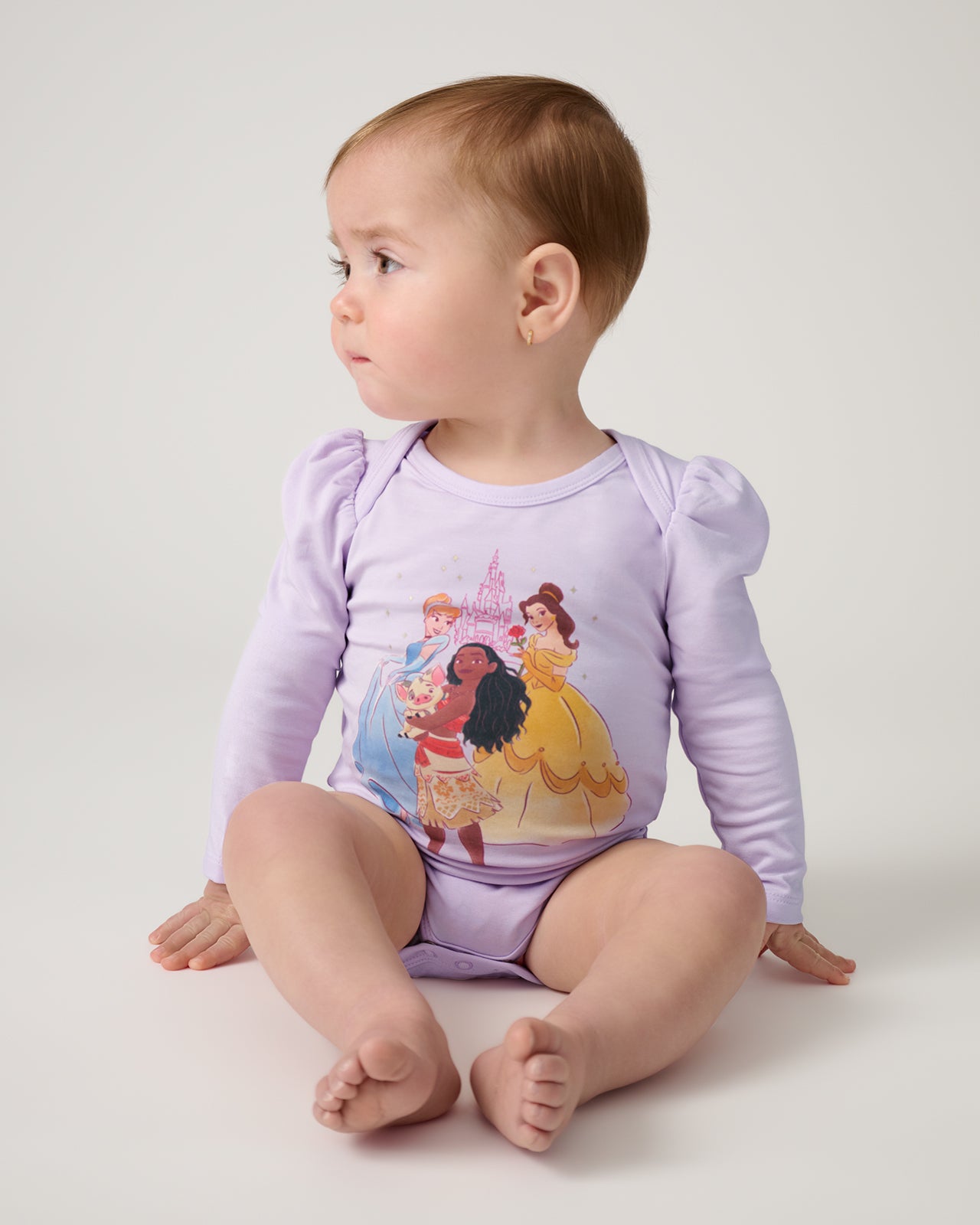 Sitting baby wearing the Disney Castle Daydream Puff Sleeve Bodysuit