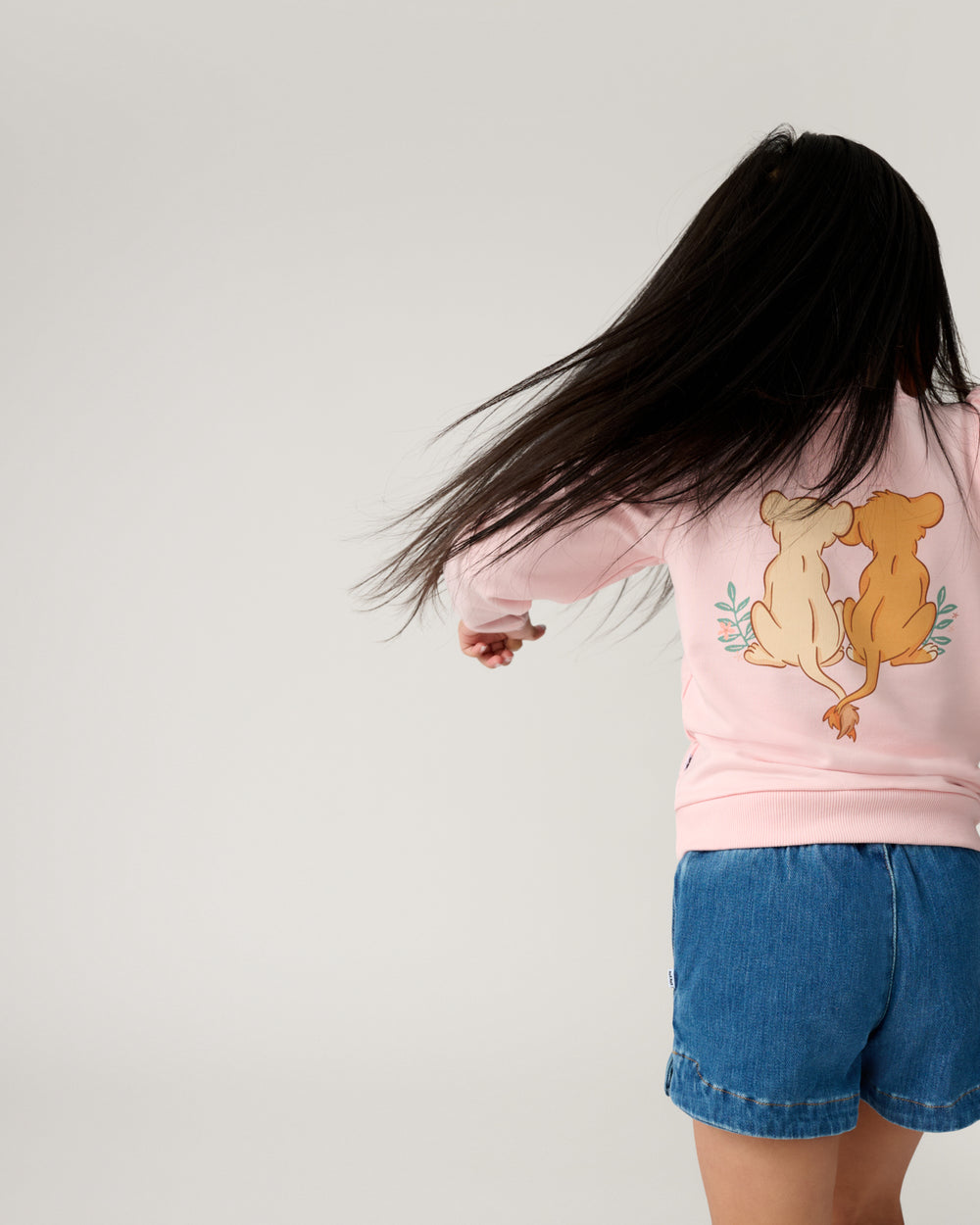 Back view of girl wearing the Disney Cub Club Puff Sleeve Crewneck