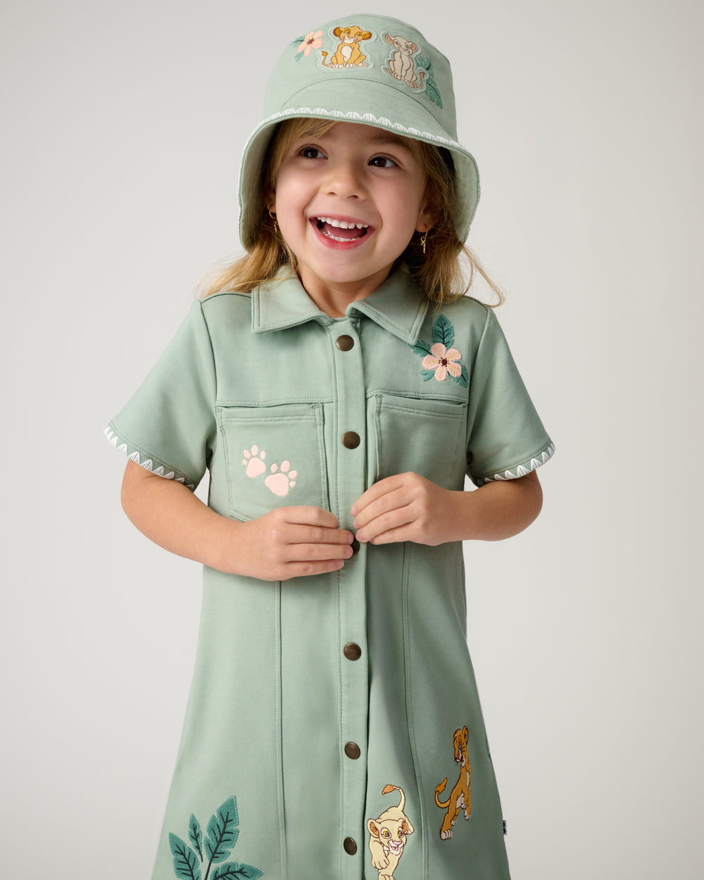 Girl wearing the Disney Cub Club Bucket Hat with the matching dress