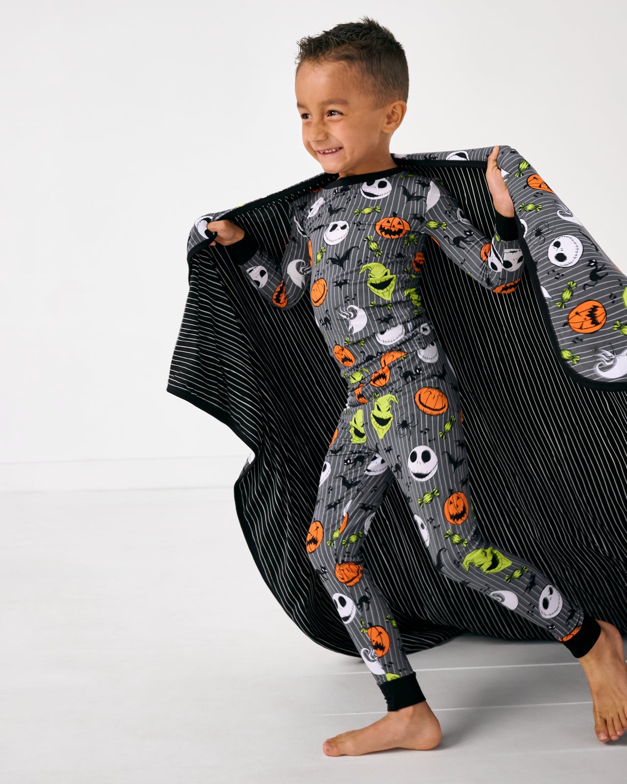 Running child holding the Disney The Nightmare Before Christmas Large Cloud Blanket®