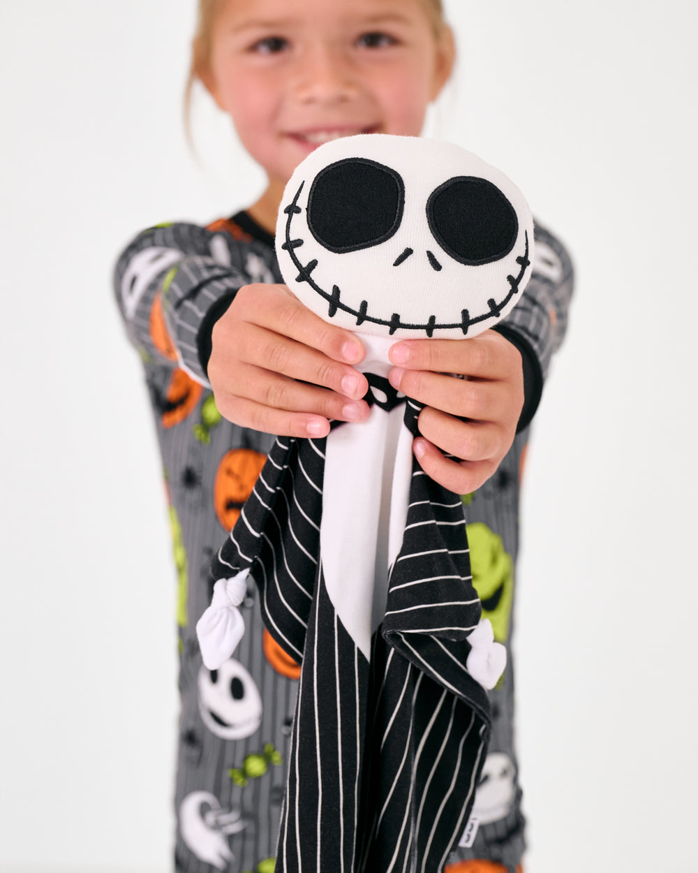 Child holding up the Disney Jack Skellington Lovey