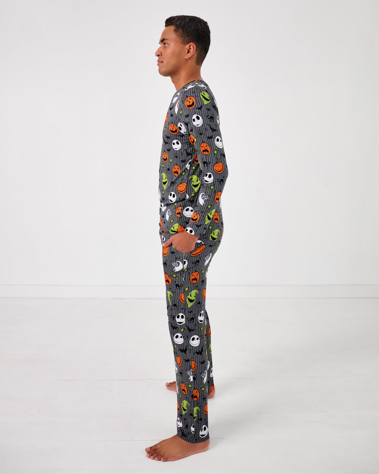 Side view of standing man wearing the Disney The Nightmare Before Christmas Men's Pajama Pants 