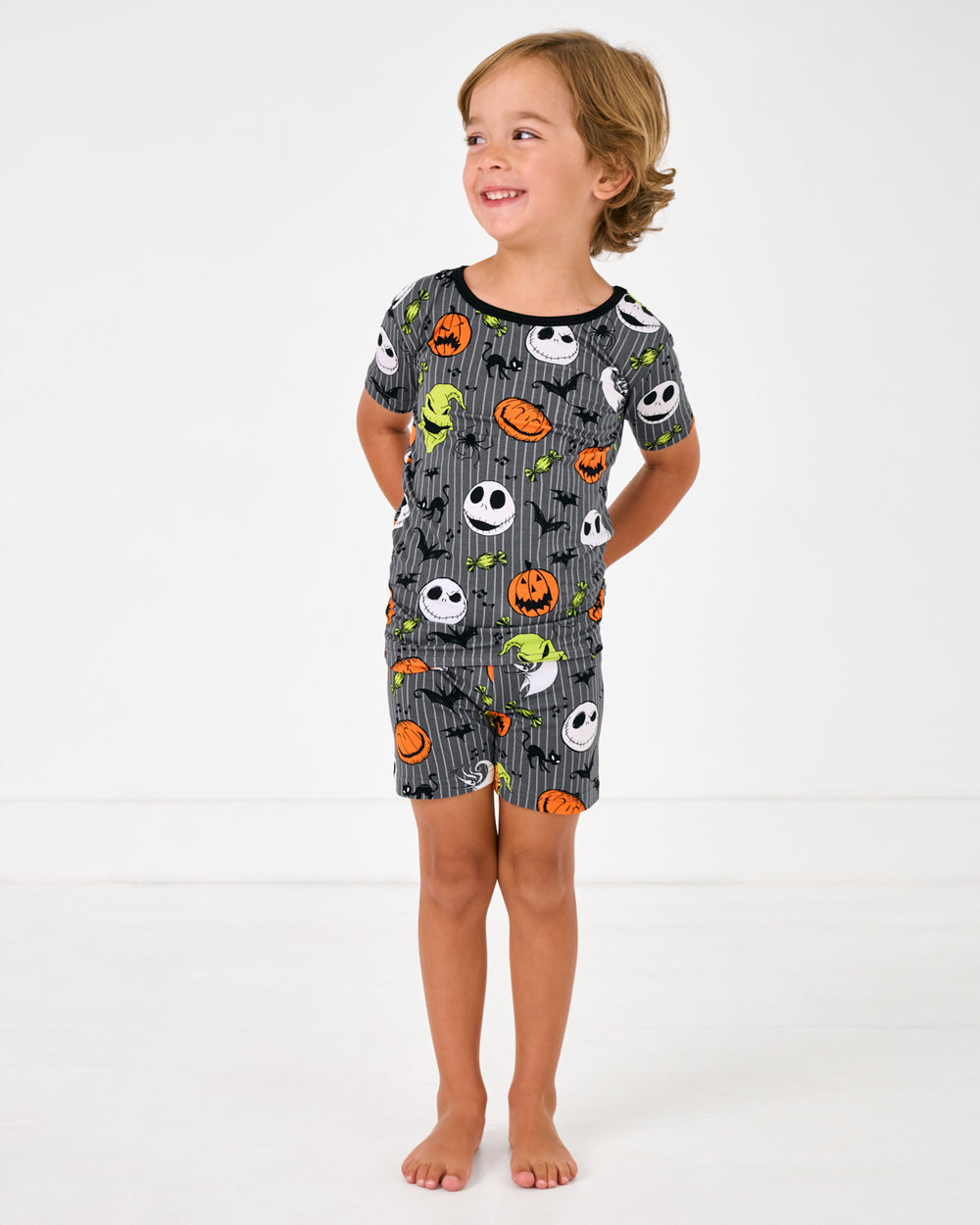 Standing boy wearing the Disney The Nightmare Before Christmas Two-Piece Short Sleeve & Shorts Pajama Set