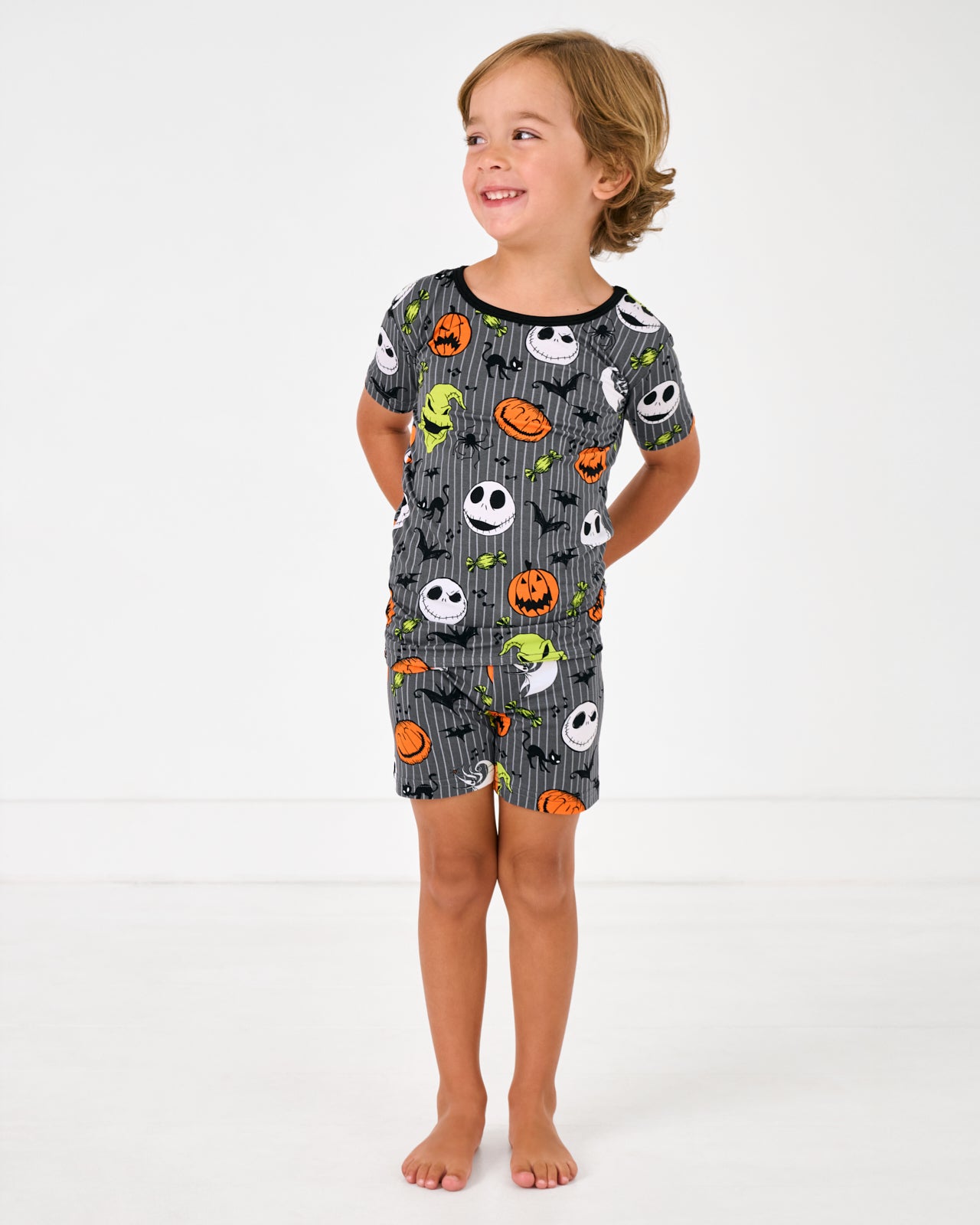 Standing boy wearing the Disney The Nightmare Before Christmas Two-Piece Short Sleeve & Shorts Pajama Set