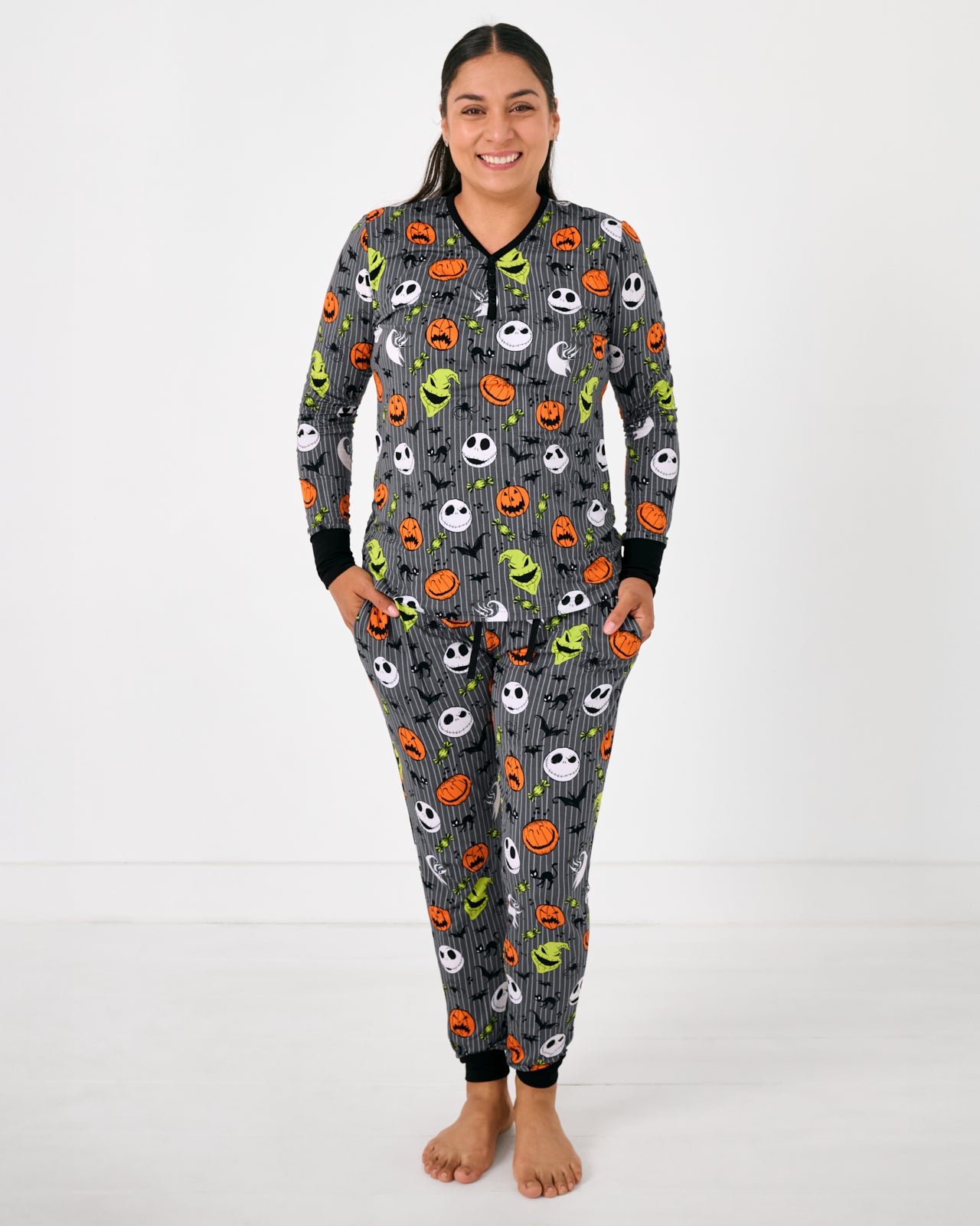 Standing woman wearing the Disney The Nightmare Before Christmas Women's Pajama Pants with a coordinating top