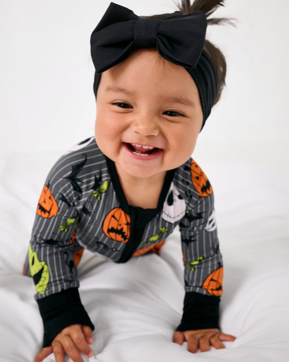 Crawling child wearing the Disney The Nightmare Before Christmas Zippy