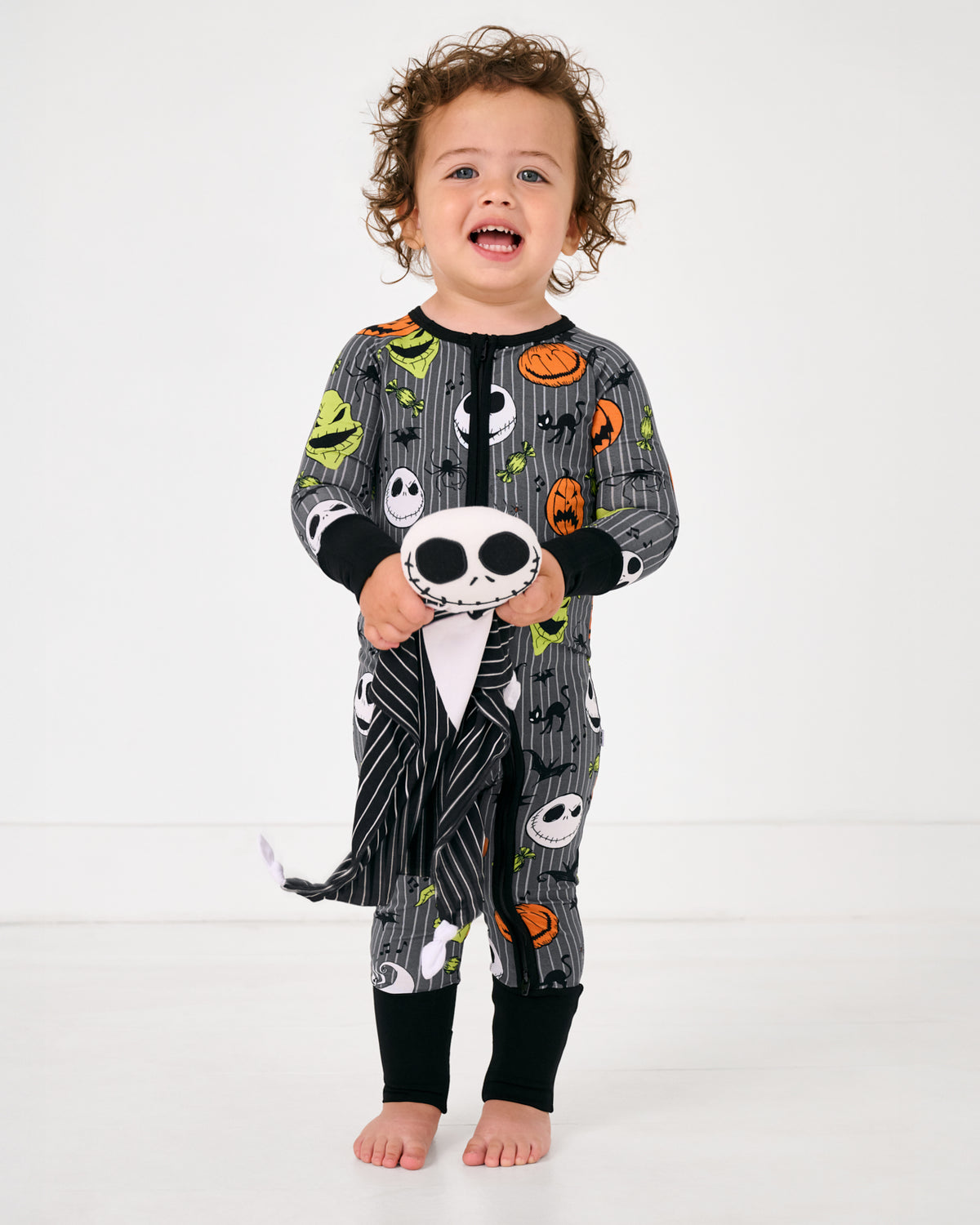 Standing toddler holding the Disney Jack Skellington Lovey