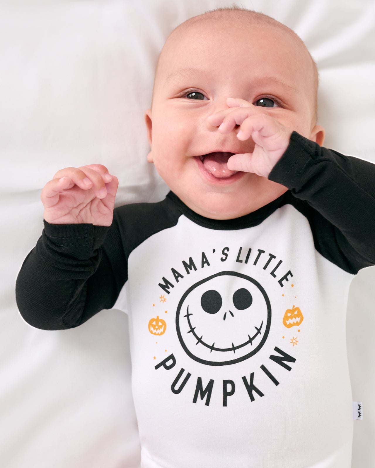 Close up of baby wearing the Disney Mama's Little Pumpkin Raglan Bodysuit