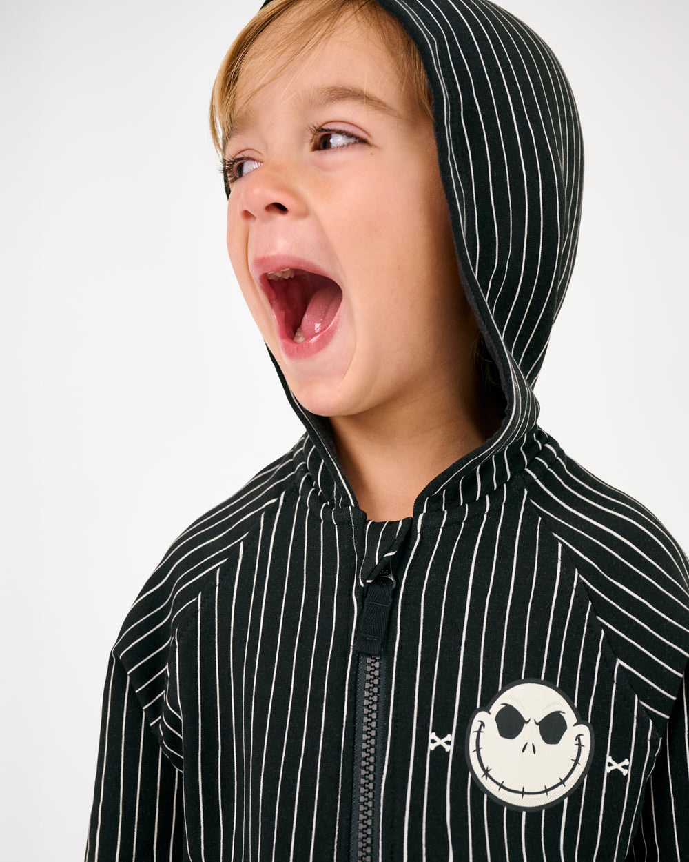 Boy wearing the Disney Jack Skellington Zip Hoodie with the hood on