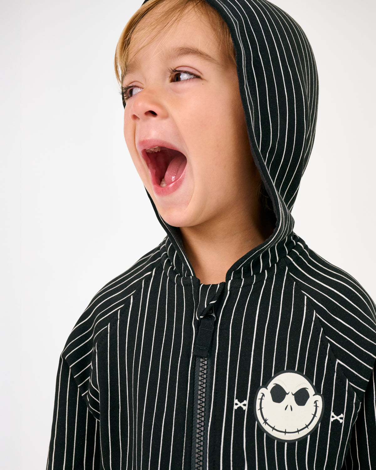 Boy wearing the Disney Jack Skellington Zip Hoodie with the hood on