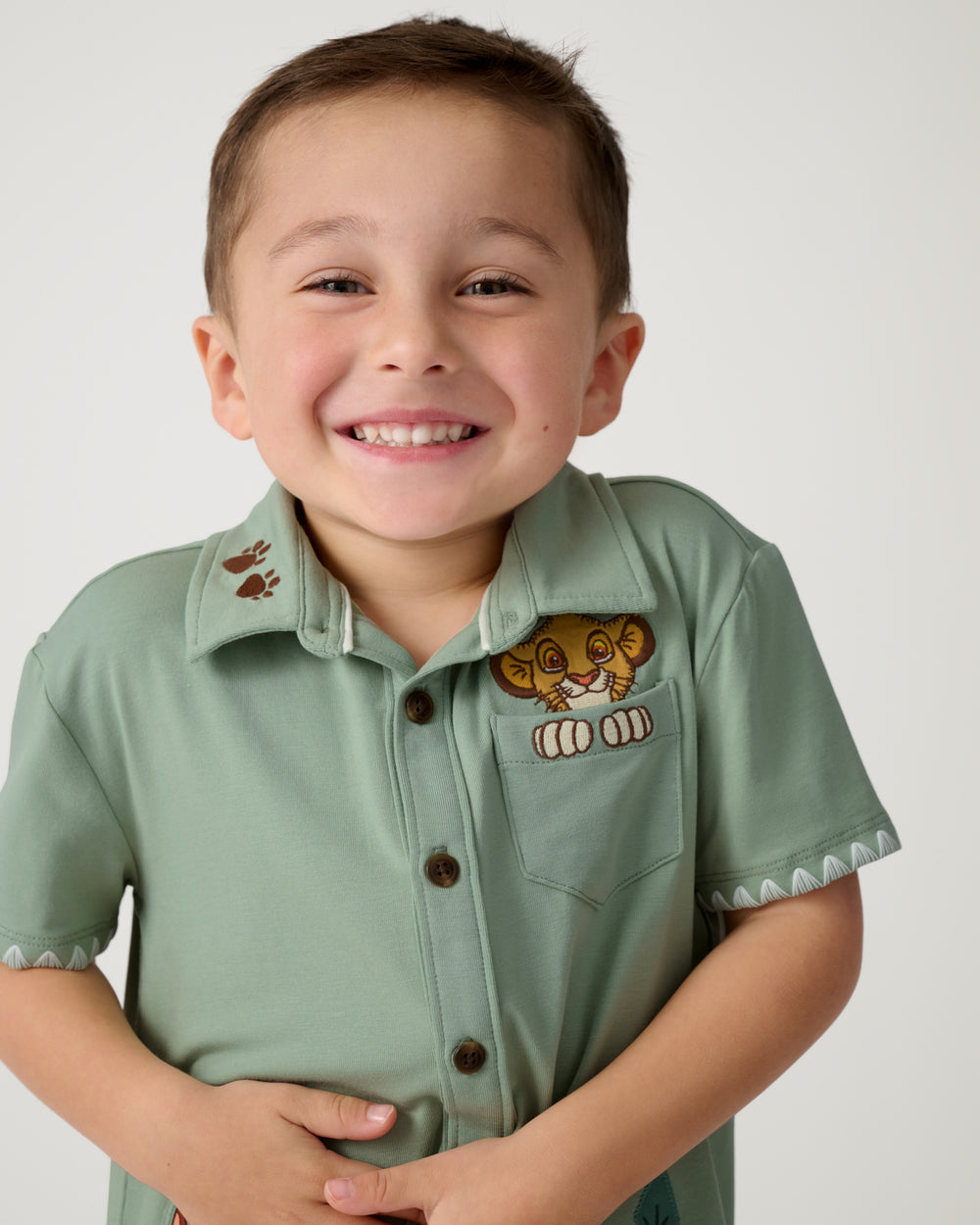 Close up of boy wearing the Disney Jungle Trio Button Down Shirt
