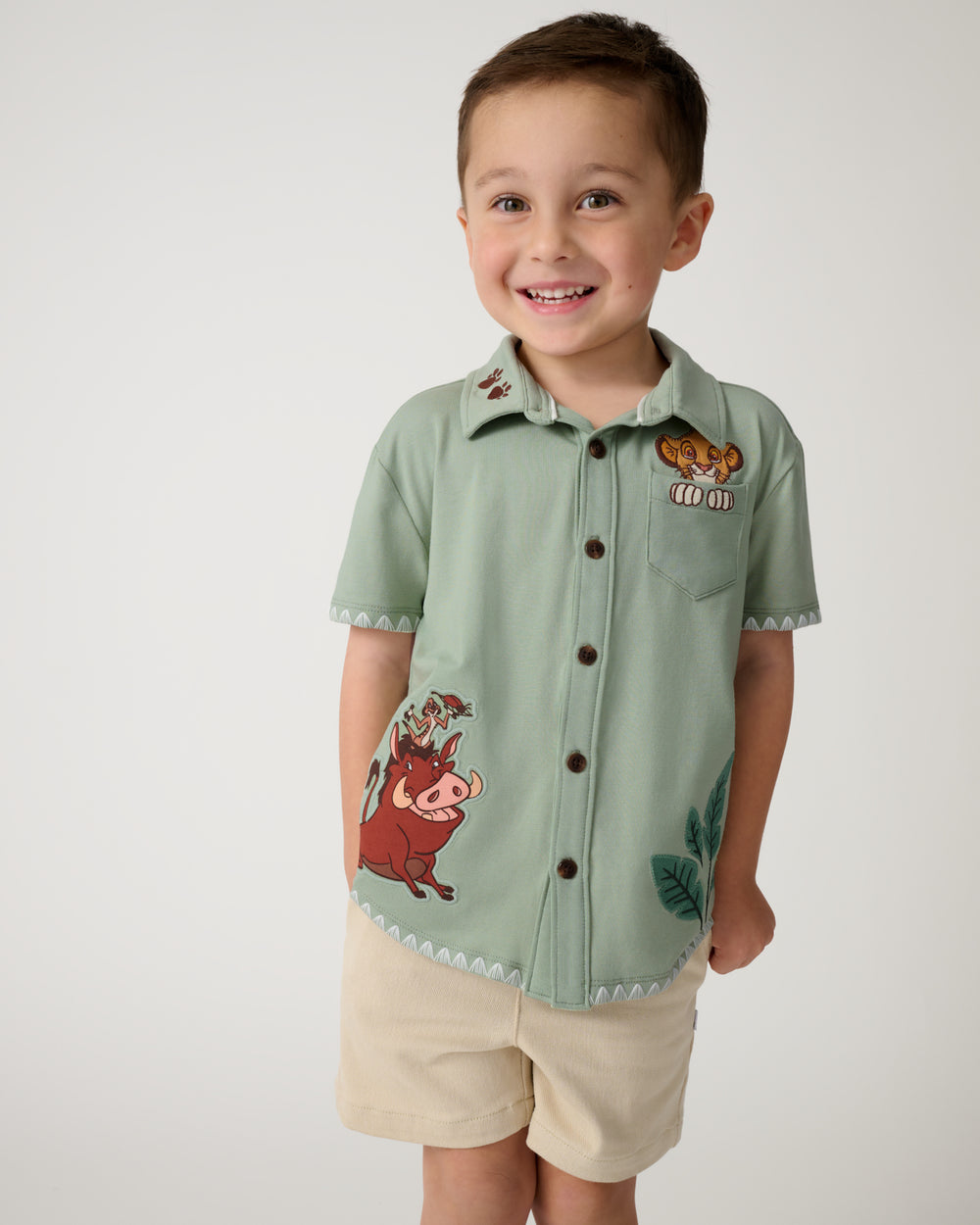 Boy wearing the Disney Jungle Trio Button Down Shirt with khaki shorts