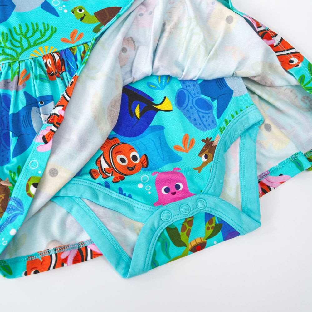Flat lay of the snap button detail on the Disney Nemo's Reef Skater Dress with Bodysuit