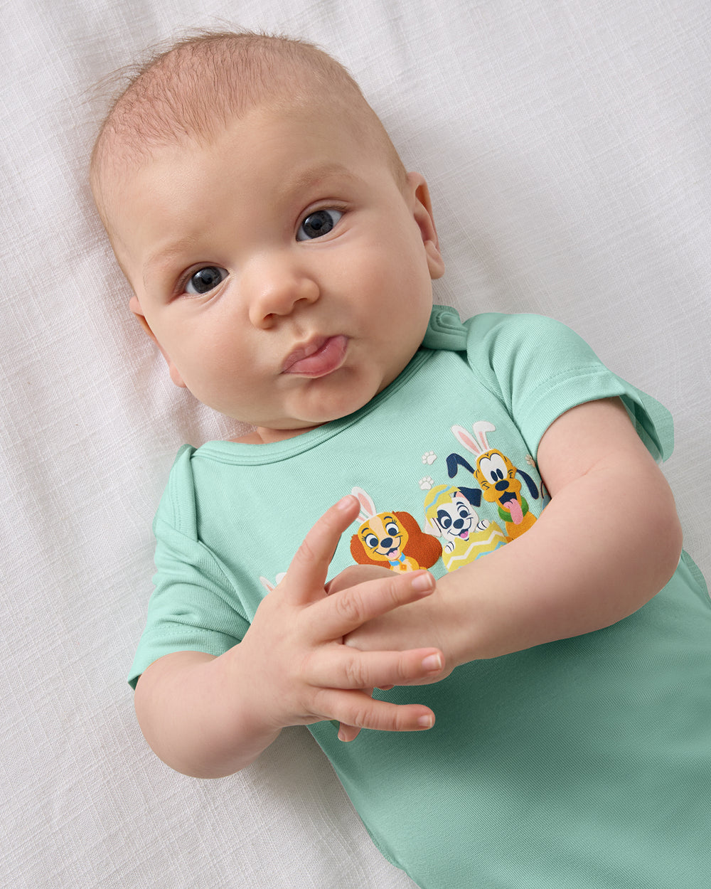 Close up overhead view of baby wearing the Disney Peekaboo Pets Bodysuit