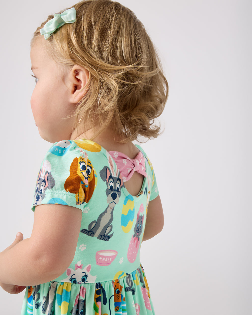 Close up of the bow detail on the Disney Peekaboo Pets Bow Back Skater Dress with Bodysuit