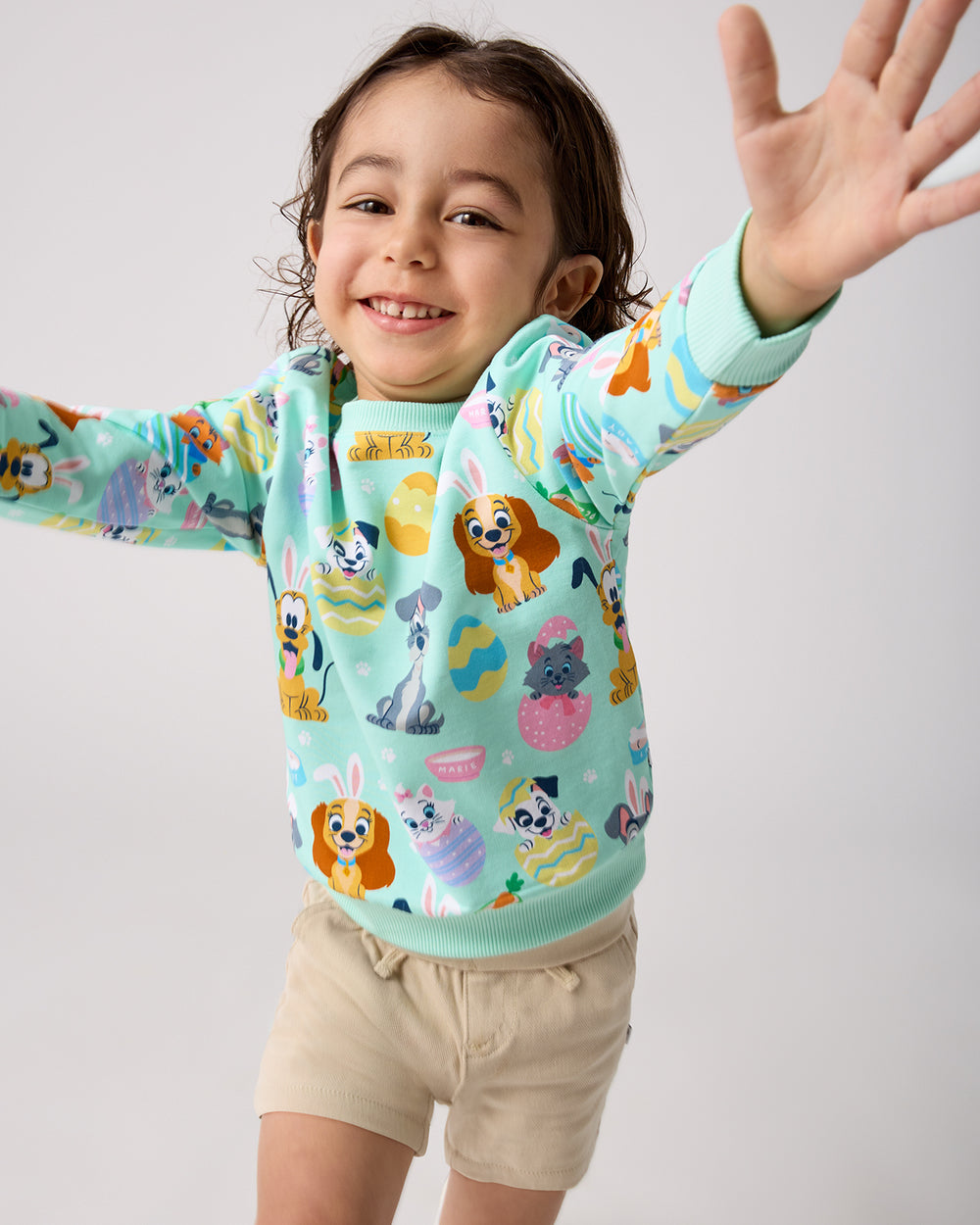 Child in motion wearing the Disney Peekaboo Pets Crewneck Sweatshirt