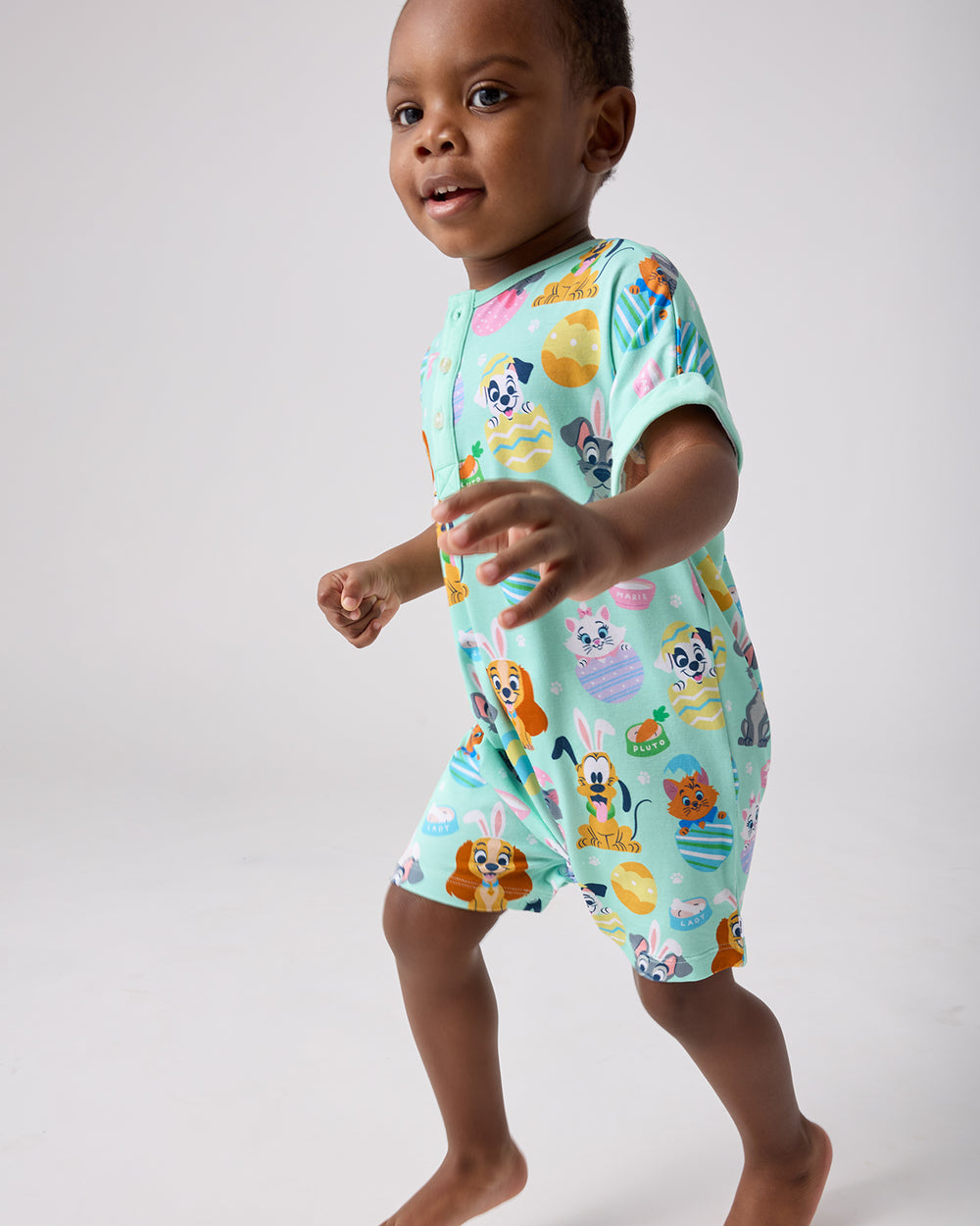 Child in motion wearing the Disney Peekaboo Pets Dolman Henley Romper