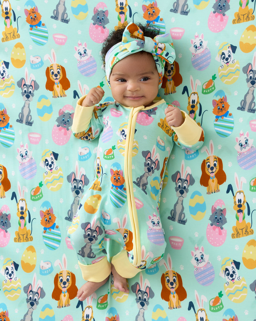 Baby laying on the Disney Peekaboo Pets Fitted Crib Sheet