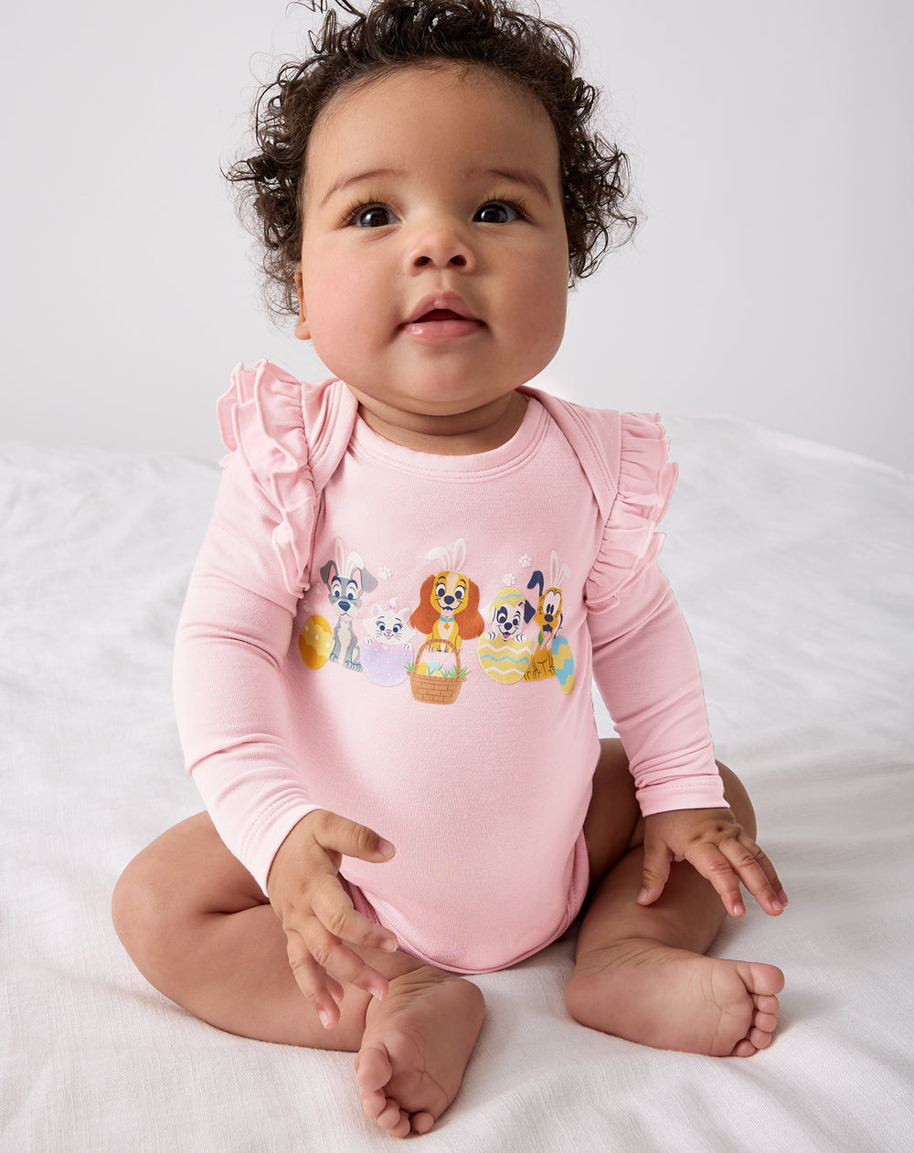 Sitting baby wearing the Disney Peekaboo Pets Flutter Bodysuit