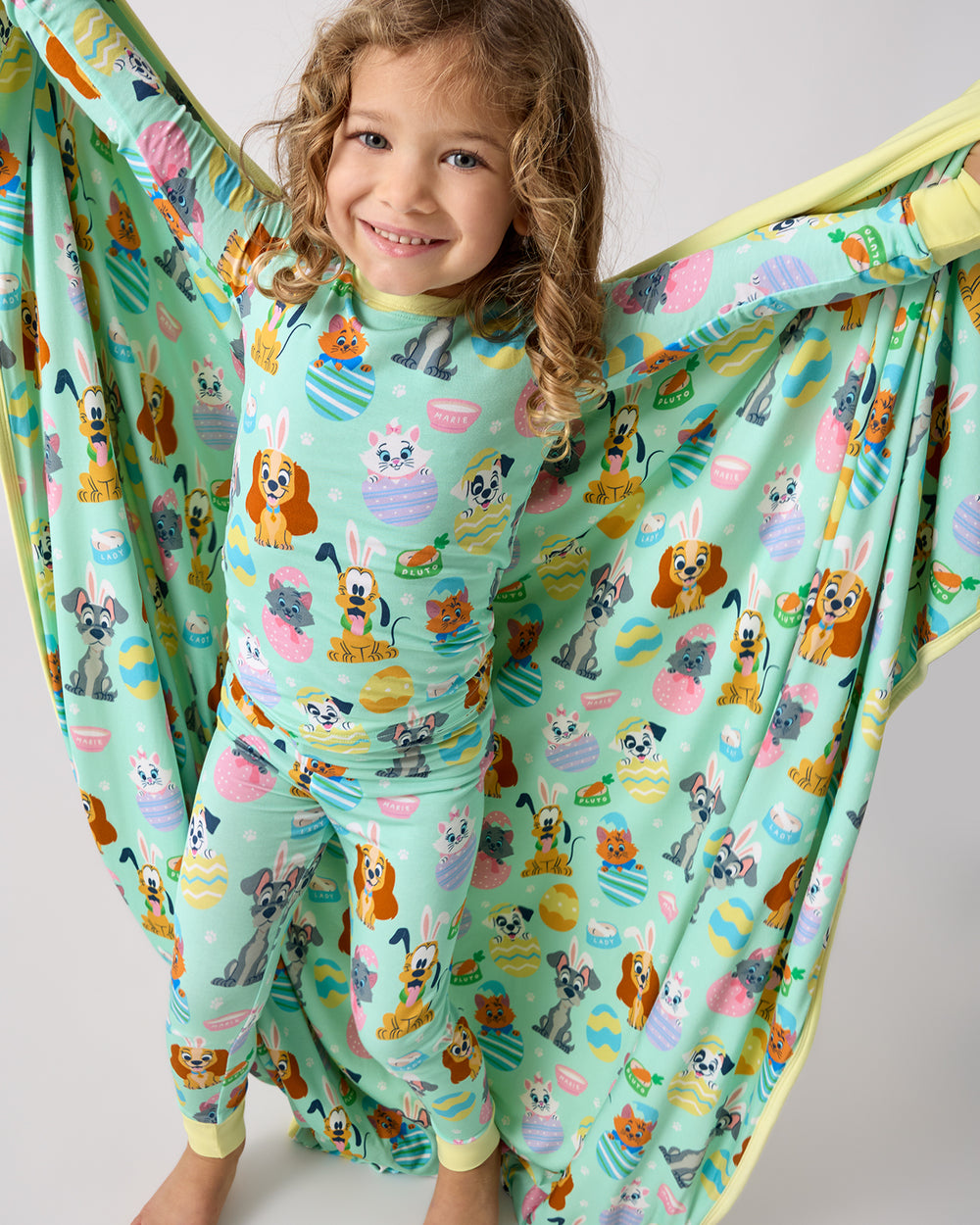 Girl wearing the Disney Peekaboo Pets Two-Piece Pajama Set holding the matching blanket